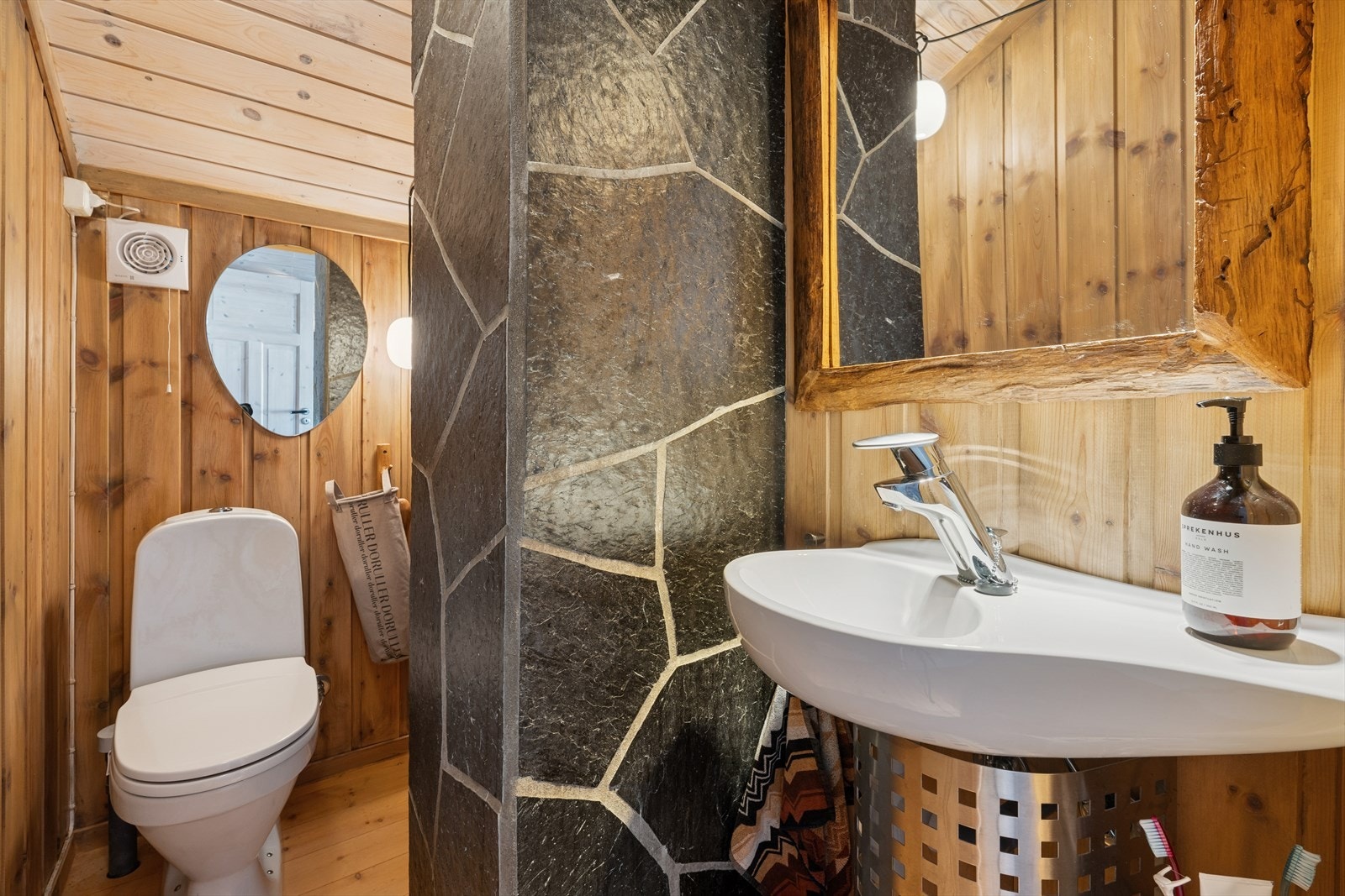 Praktisk toalettrom i andre etasje med gulvmontert toalett og vegghengt porselensservant. Galleribilde