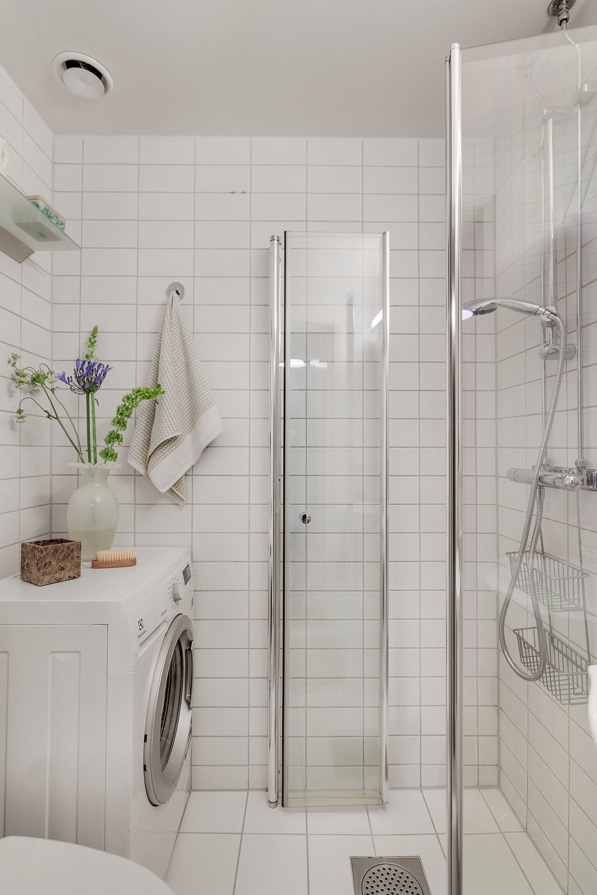 Dusj med innfellbare dører i herdet glass, servant, toalett samt opplegg for vaskemaskin. Galleribilde