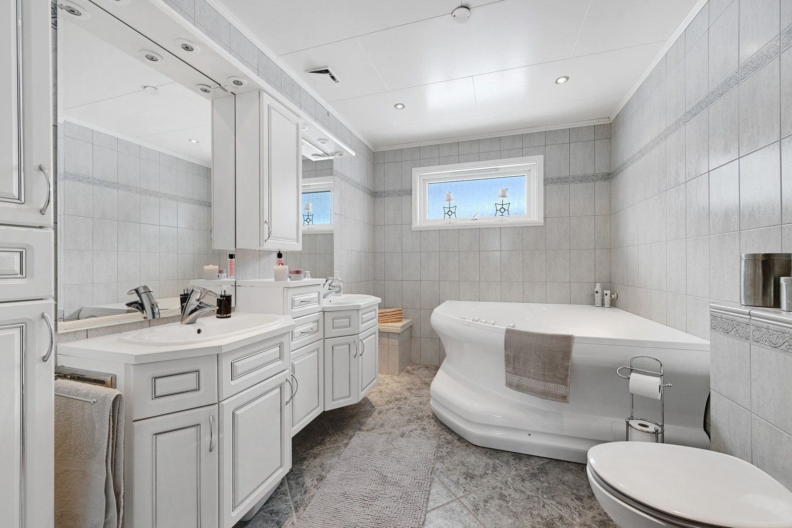 Flislagt bad i hovedetasjen med boblebad og flott innredning Galleribilde