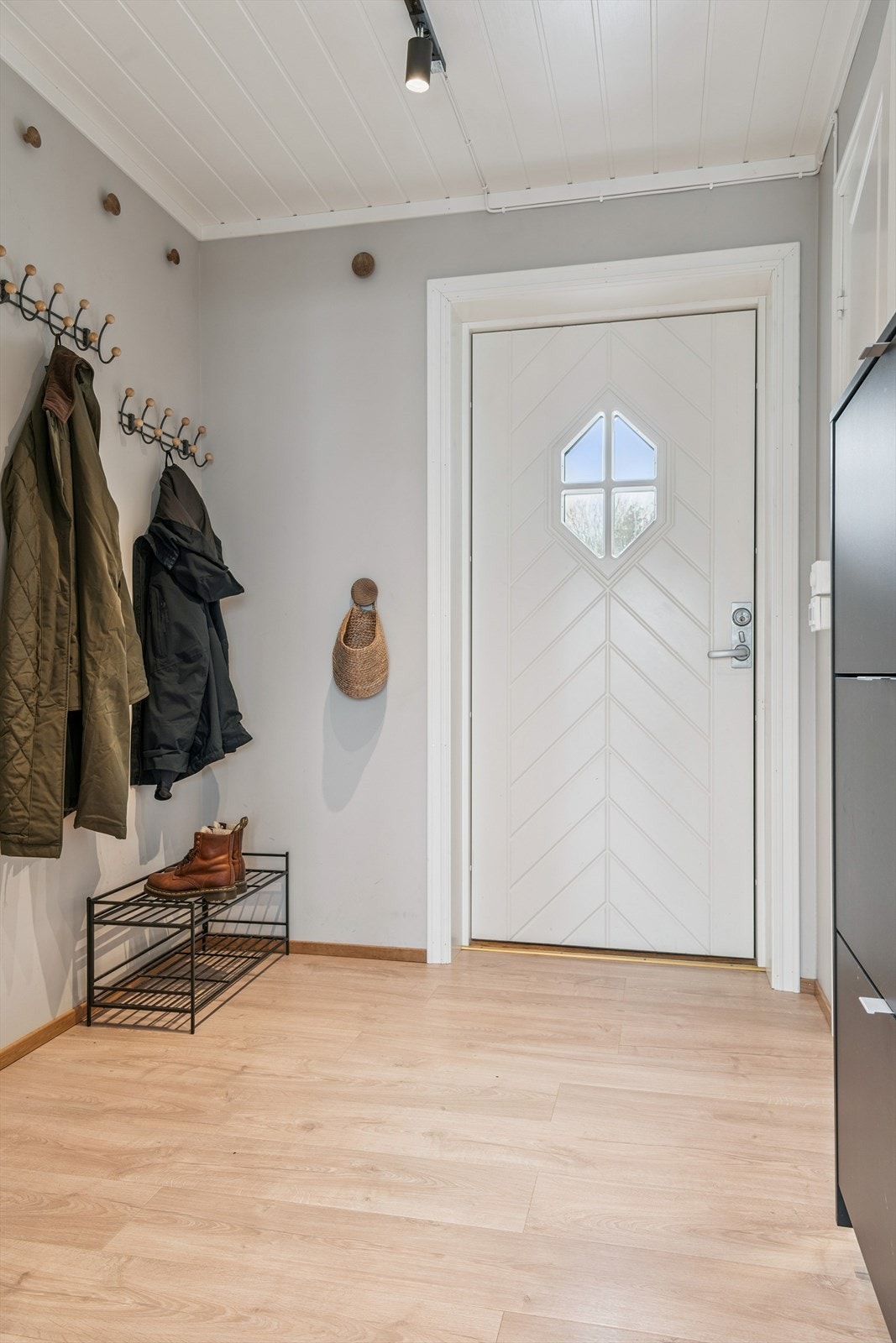Inngangspartiet i hovedetasjen vender mot vest, og har plass til enkel oppbevaring av yttertøy og sko. Galleribilde