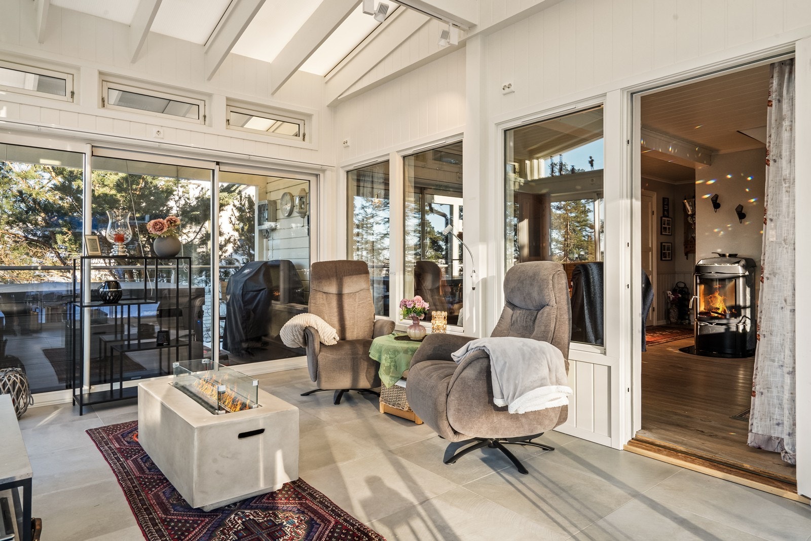 Skyvbare glassvegger i hagestuen gir lys og romfølelse året rundt. Galleribilde