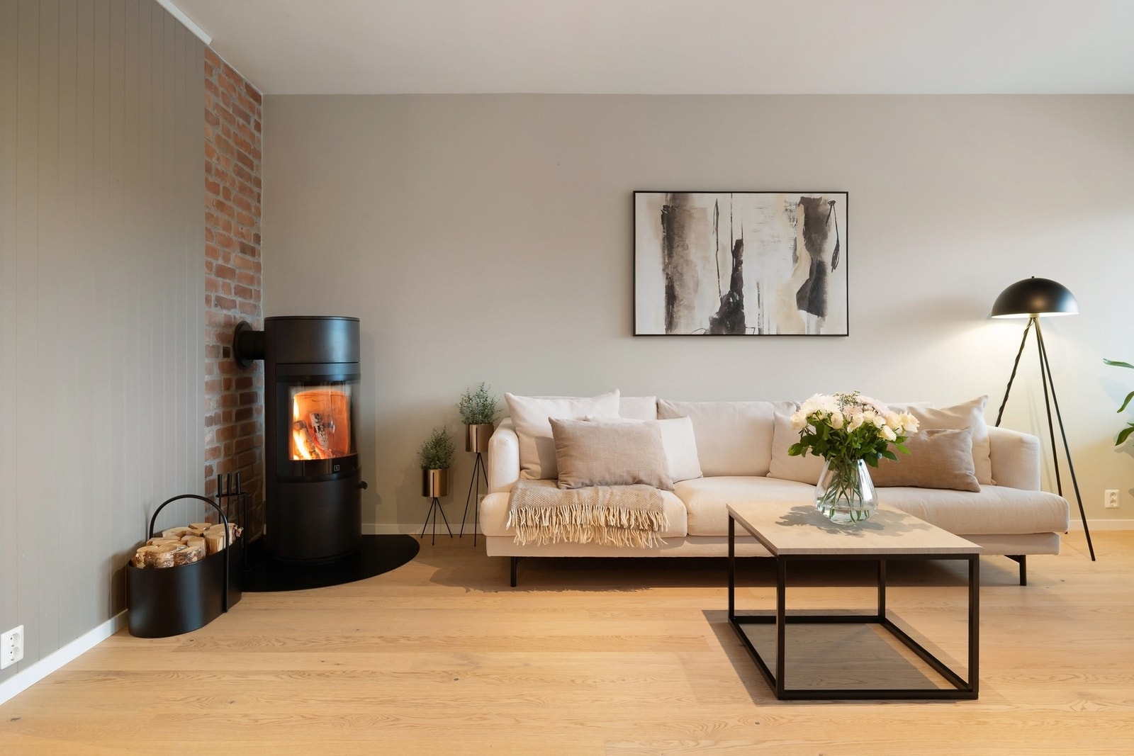 I hjørnet av stuen er det peisovn med stilfull, original tegnsteinsvegg Galleribilde