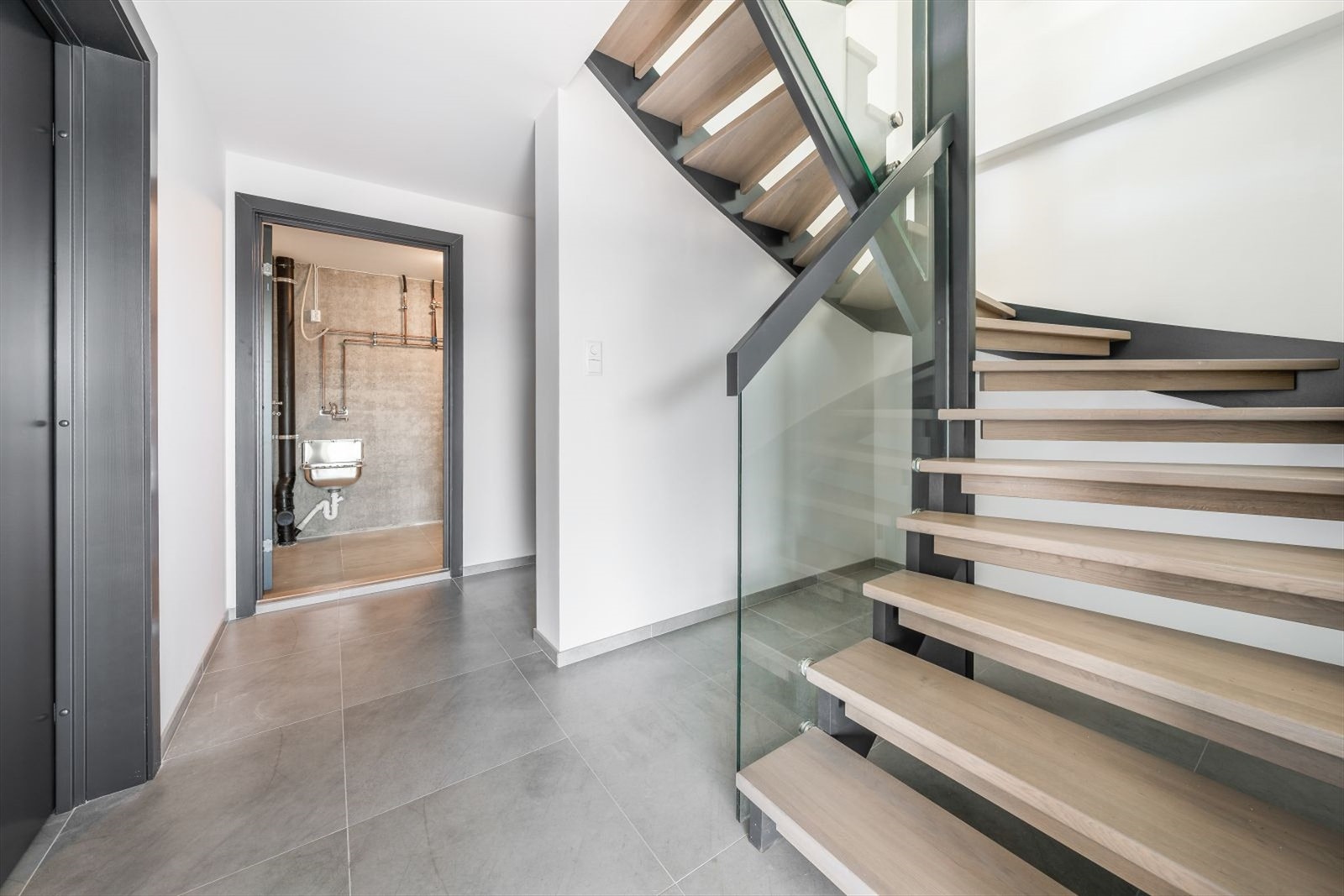 Boligs underetasje inneholder vaskerom, sportsbod og utgang til carport. Galleribilde