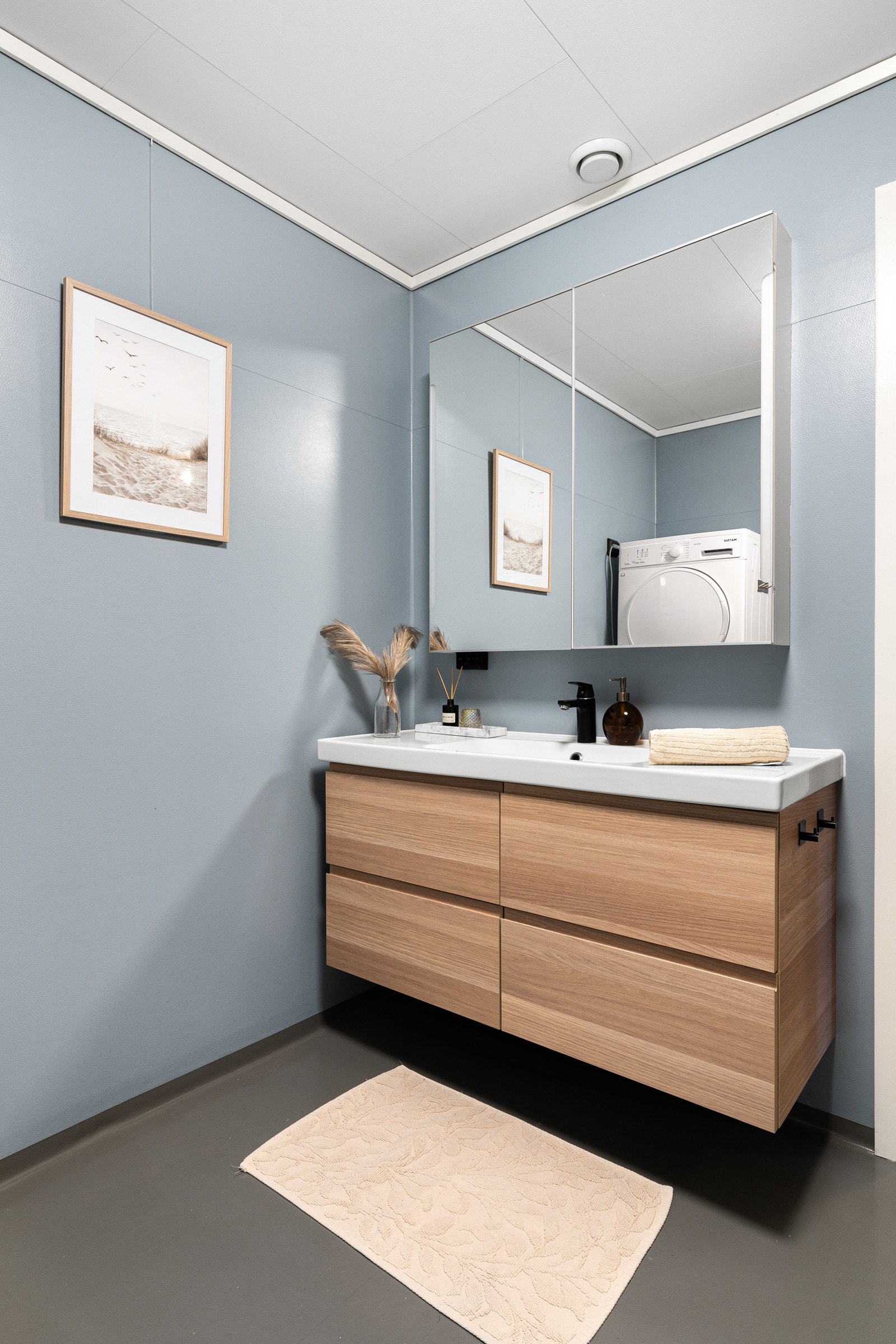 Rommet er innredet med servant på skuffeseksjon og speil. Baderomsinnredningen er fra 2023. Galleribilde