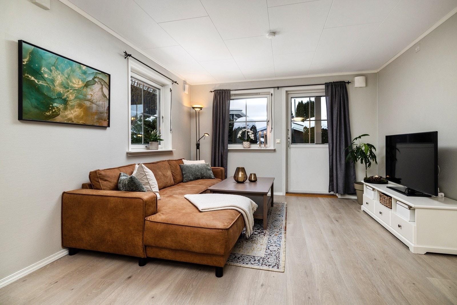 Den åpne løsningen mellom stue og kjøkken skaper en sosial og innbydende atmosfære. Galleribilde