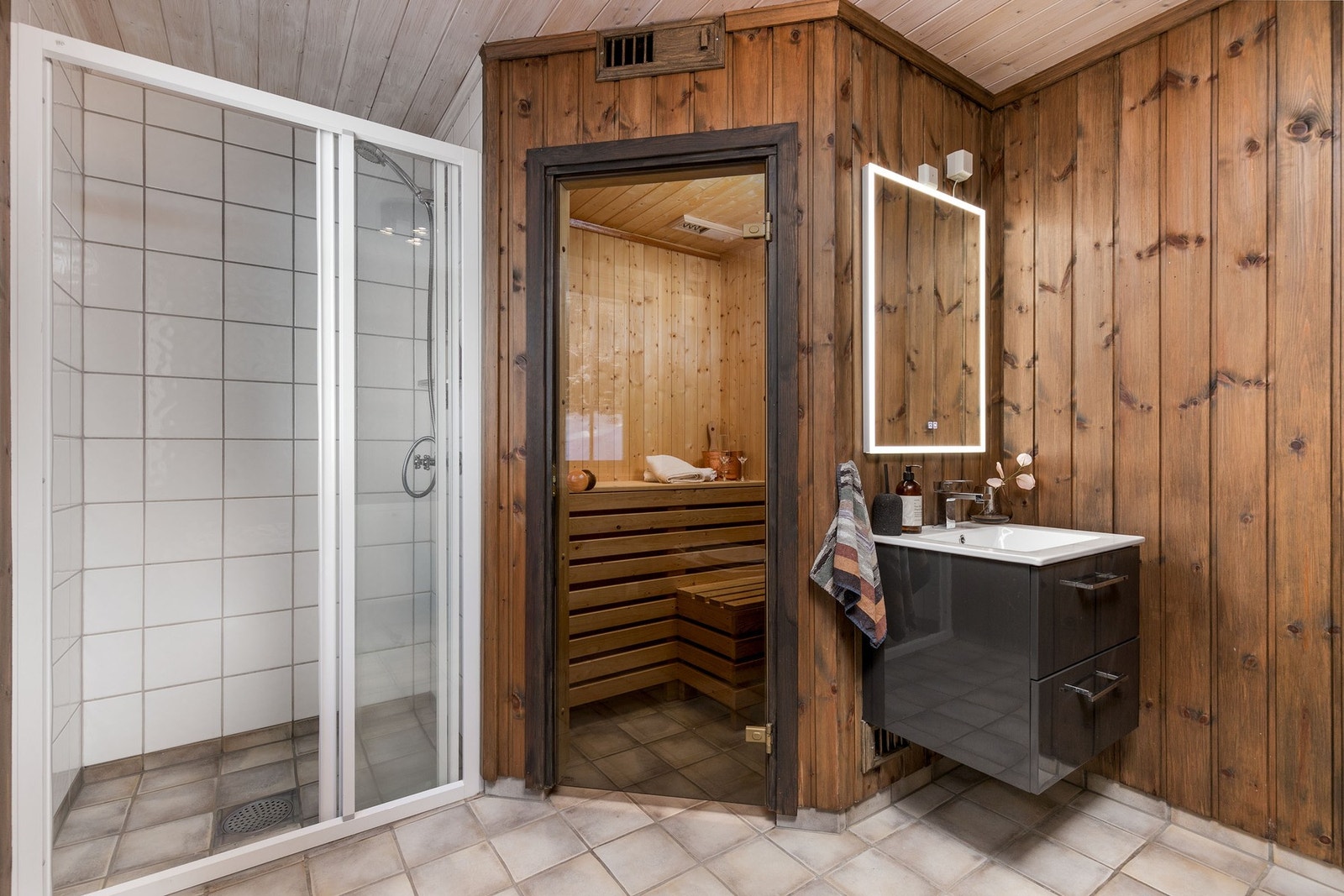 Moderne skuffeinnredning med servant, samt speil med belysning over servant. Galleribilde