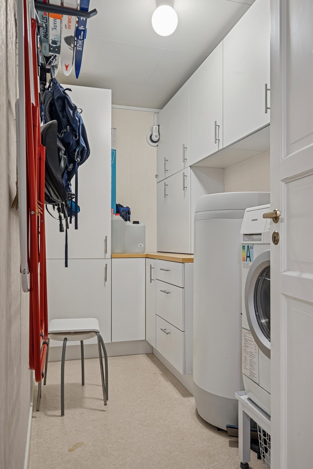 I tillegg finner du en praktisk bod som er innredet som et funksjonelt vaskerom. Her er det opplegg for vaskemaskin, og rommet er utstyrt med sluk. Gulvet har imidlertid mangelfullt fall mot sluket. Galleribilde