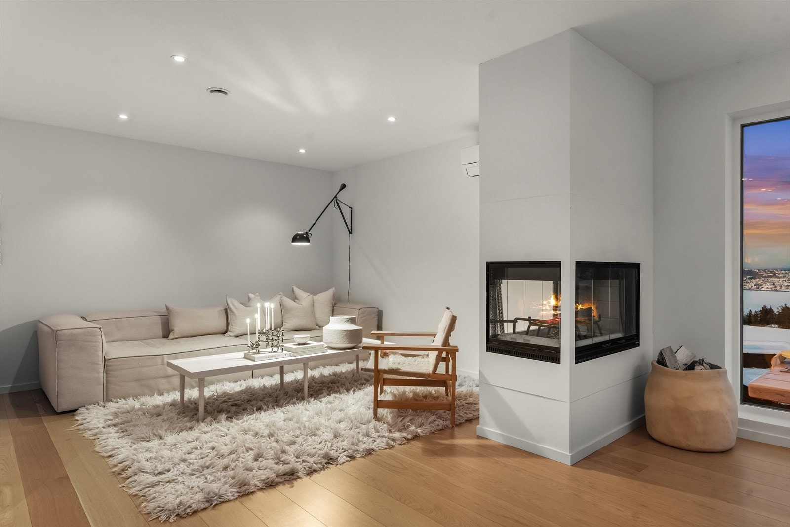 Stuen fremstår som et lunt og innbydende allrom med peisen som naturlig blikkfang. Galleribilde