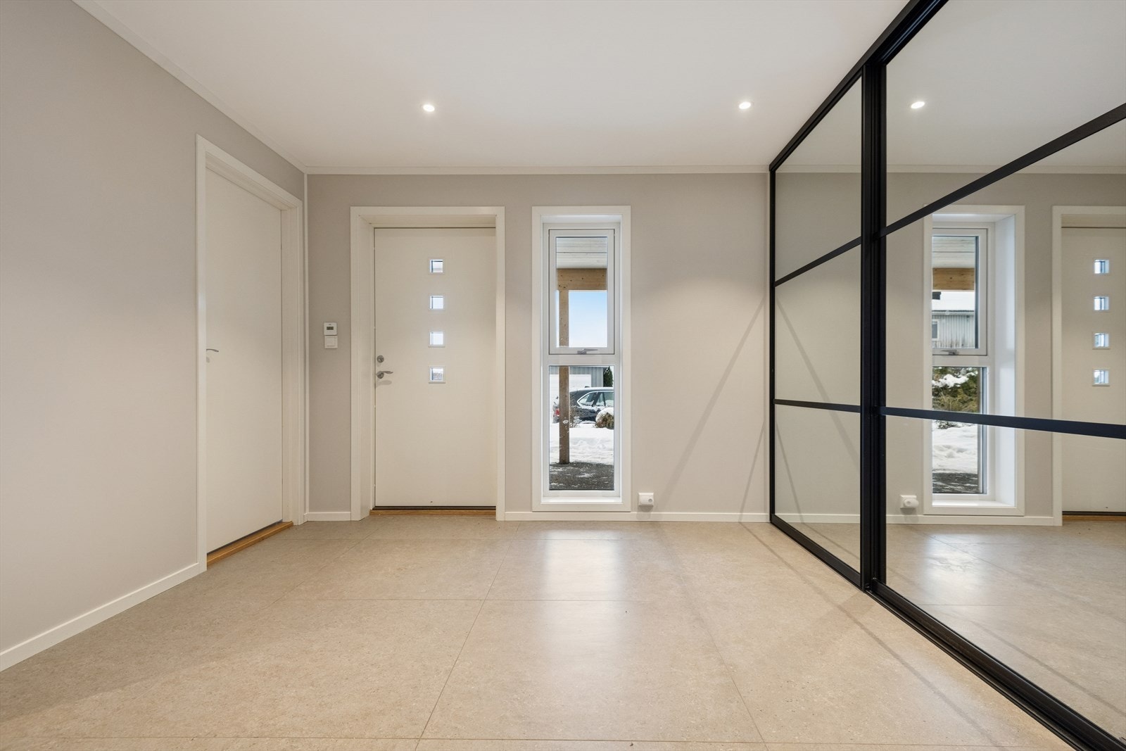 Her ønskes du velkommen inn i en lys og romslig entré som er flislagt, innredet med stor skyvedørsgarderobe med god plass til oppbevaring. Galleribilde