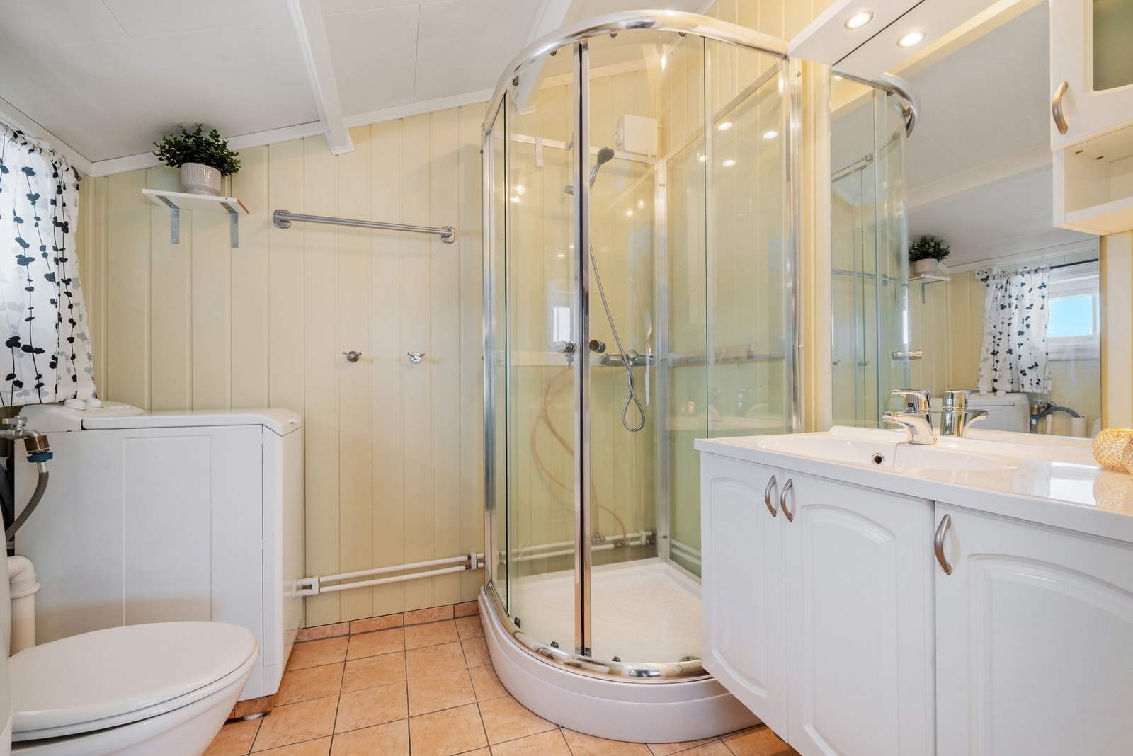 Badet er på 4,5m² med flis og varme på gulv. Galleribilde