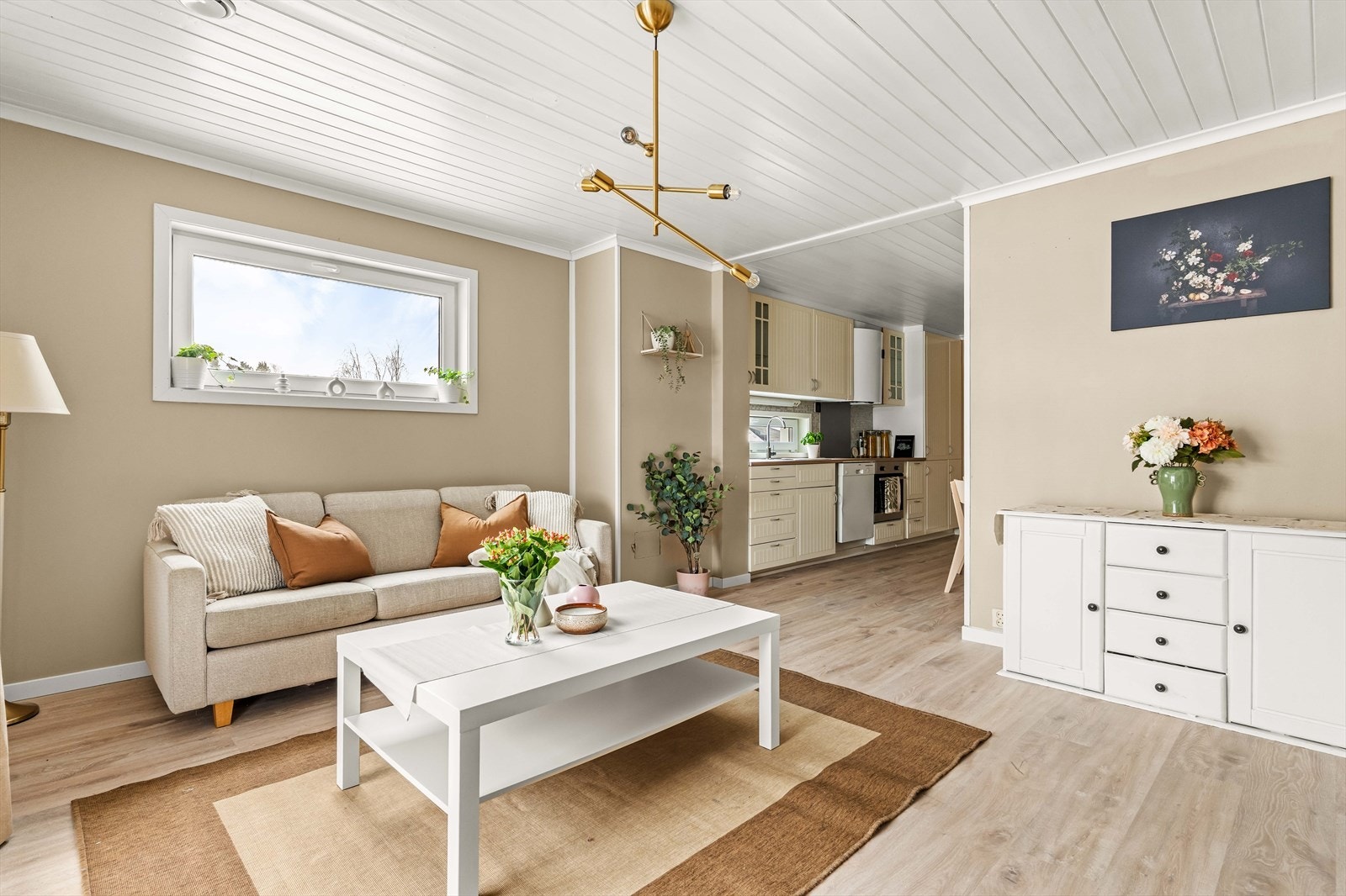 Leiligheten har en lys stue med gode vindusflater og plass til både sofagruppe og spisebord. Galleribilde