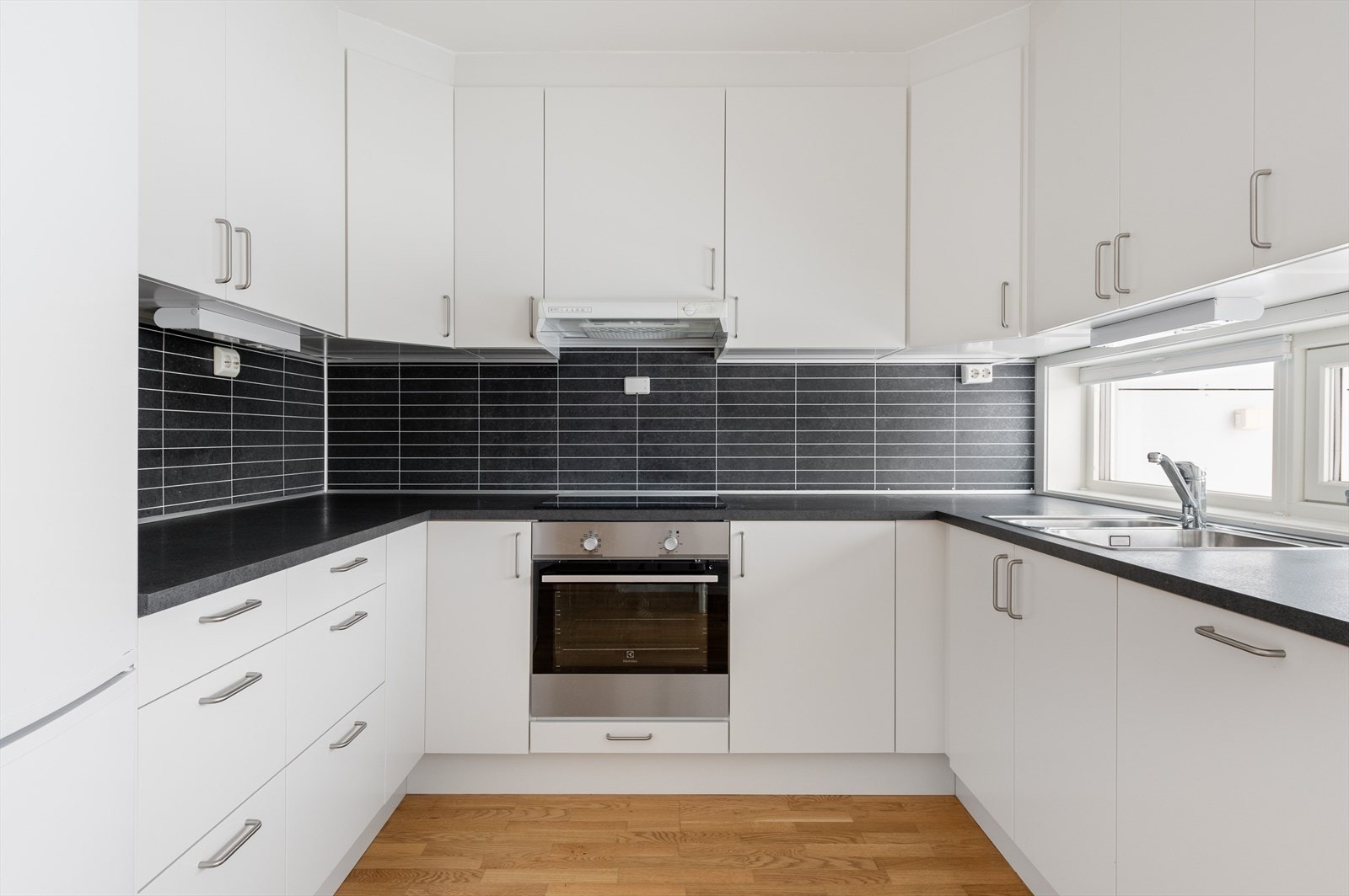 Kjøkkenet er utstyrt med integrert koketopp og stekeovn, samt tilrettelagt plass for både oppvaskmaskin og kjøleskap, noe som gir en helhetlig løsning. Galleribilde