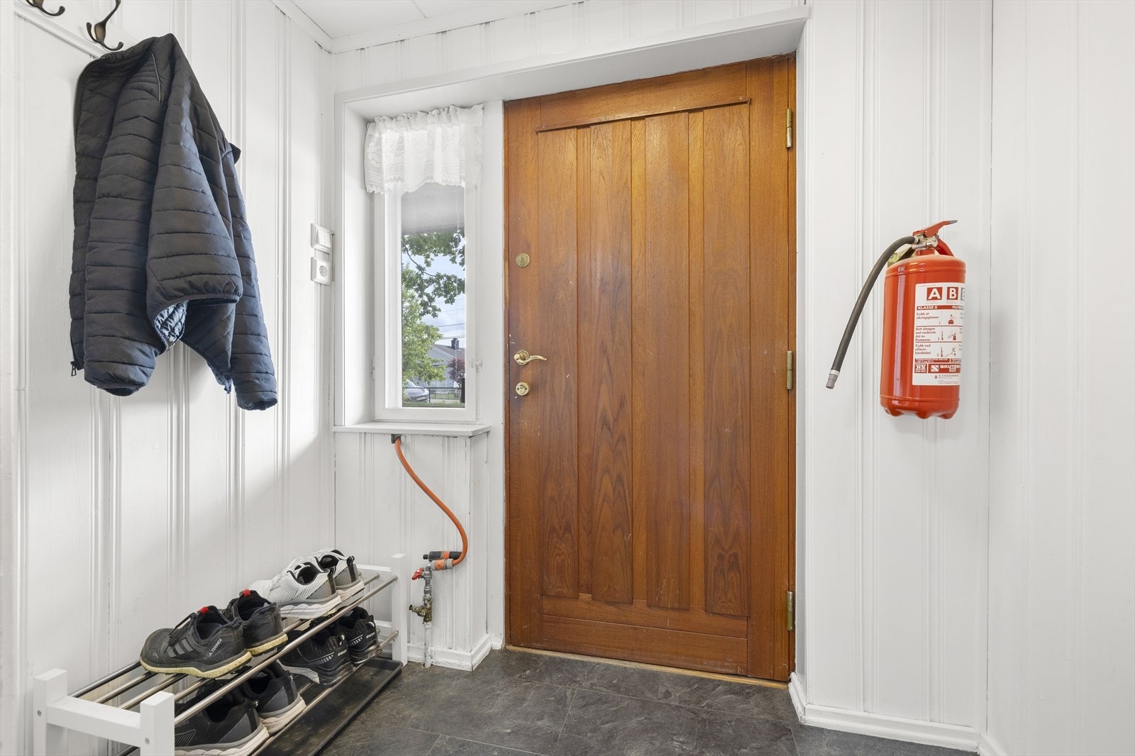 Velkommen inn! Boligen har et lite vindfang med plass til å henge fra seg yttertøy og legge fra seg sko. Galleribilde