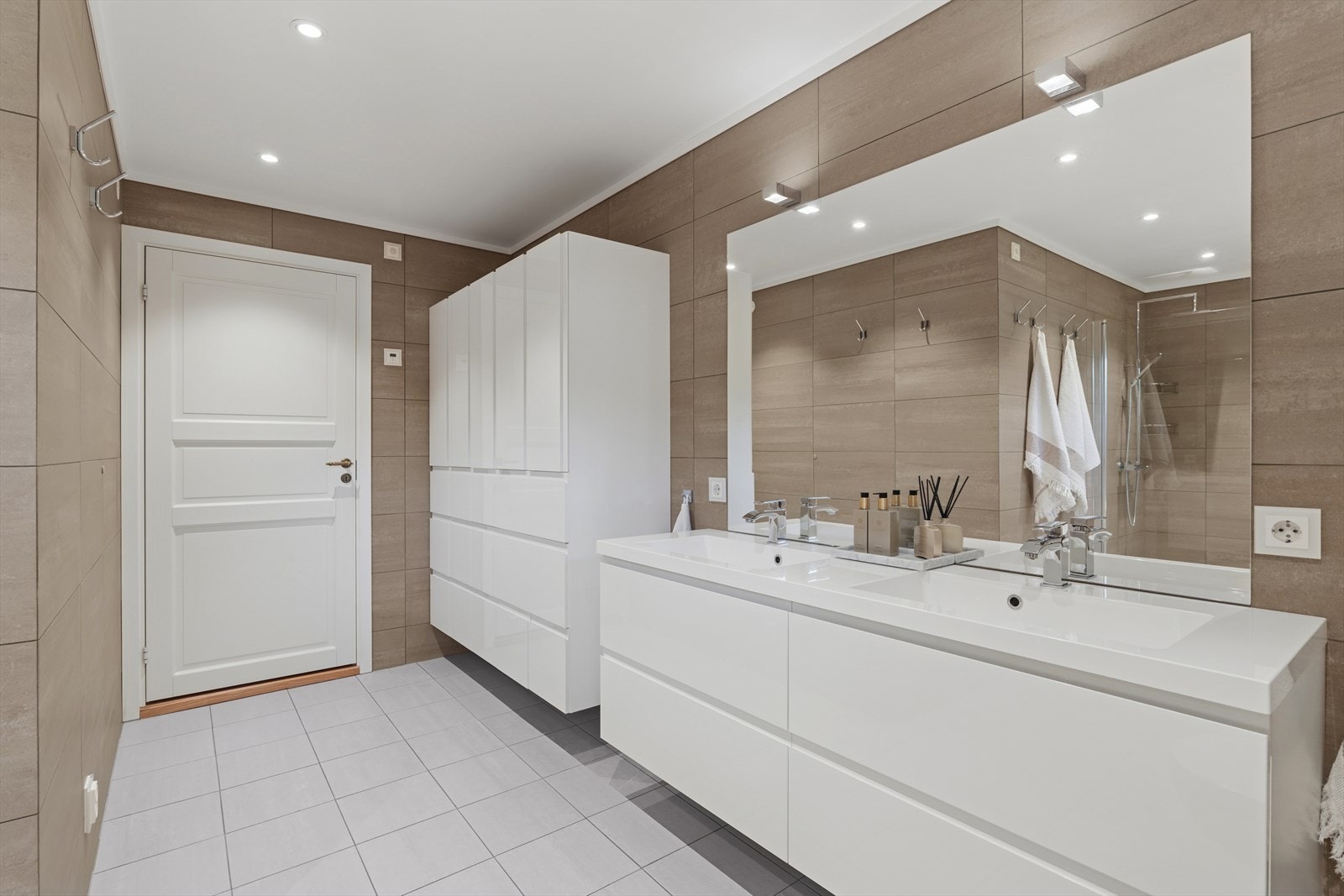 Badet ble renovert i 2018 og er tidløst og delikat innredet med grå fliser på gulv og beige fliser på vegg. I gulvet har man også varmekabler for ekstra komfort. Galleribilde