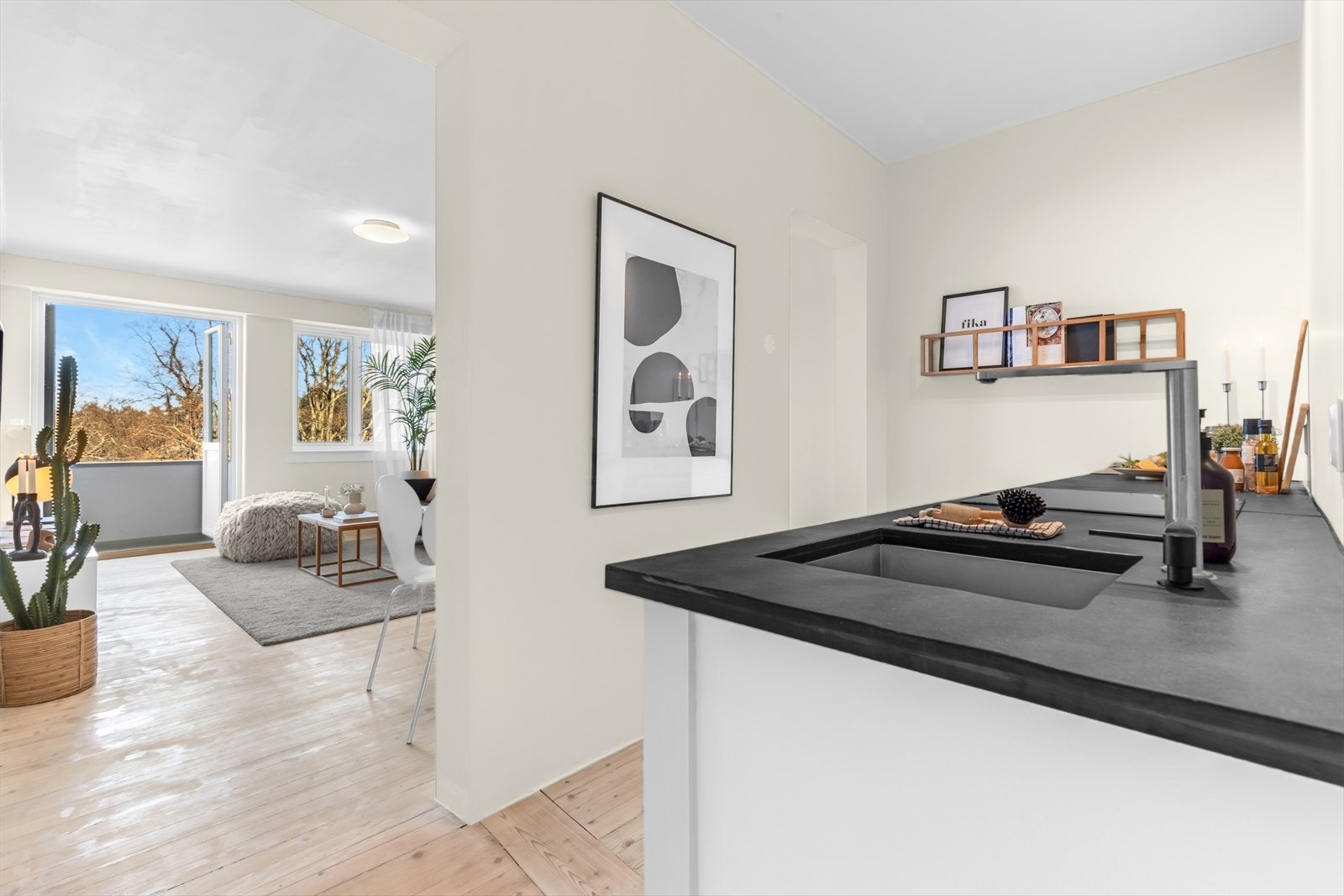 Innredningen har folierte fronter, nedfelt kjøkkenkum i steinbenkeplate, integrert induksjonstopp, stekeovn, oppvaskmaskin (smal modell) samt kjøle- og fryseskap. Galleribilde