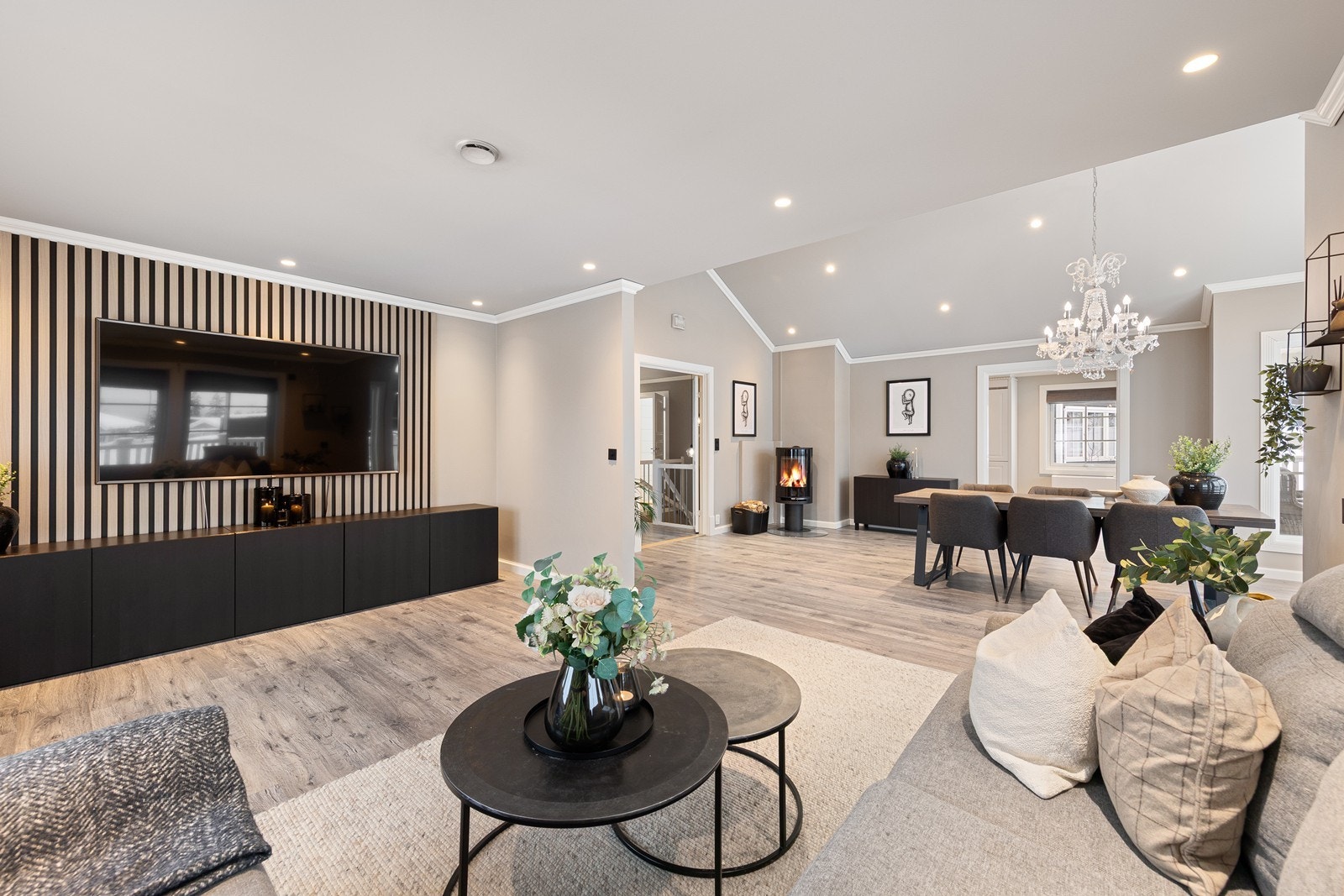 TV-kroken er innredet med god plass til en romslig sofagruppe og preges av en dekorativ kontrastvegg med spilepanel, som gir et moderne og stilfullt preg. Galleribilde