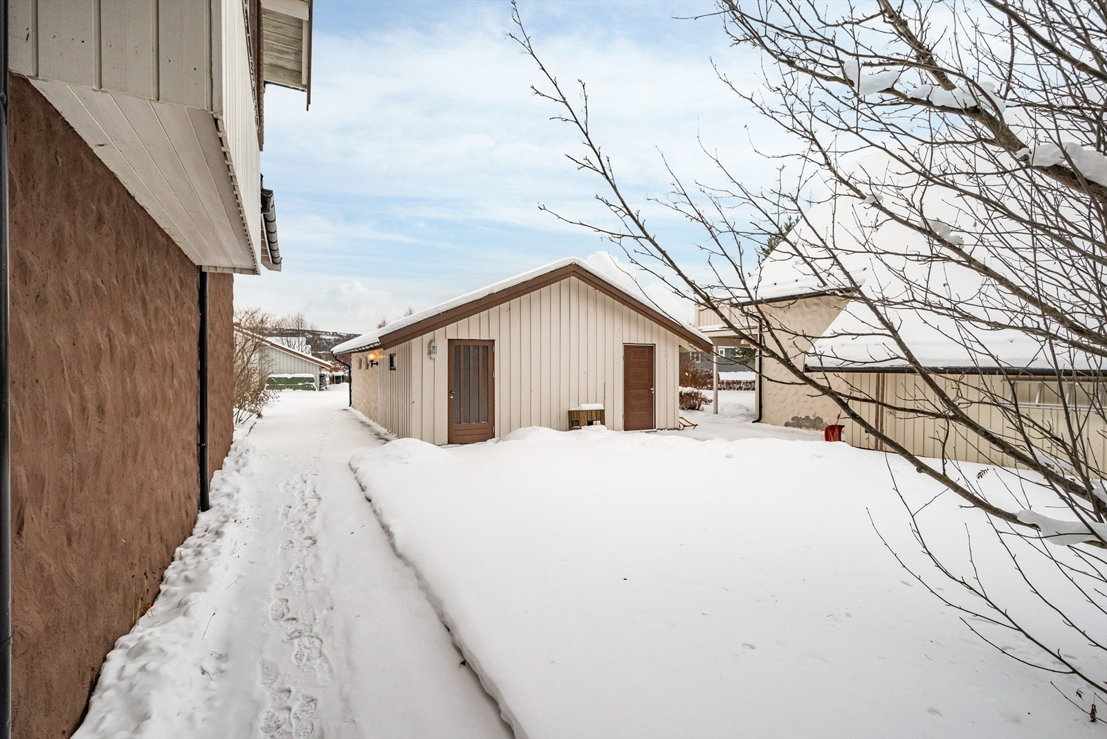 Garasjen er bygd i tomtegrensa mot naboen slik at man har hver sin halvdel. Galleribilde