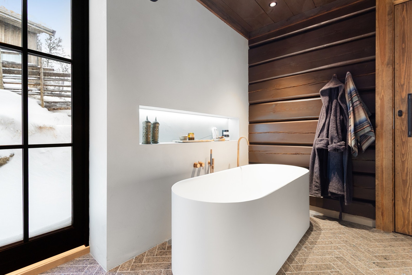 På gulv er det flis i Larvik-granitt, i fiskebeinsmønster. Integrert høyttaler i tak og lys i vegg Galleribilde