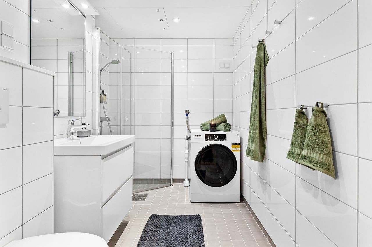 Flislagt bad med varmekabler i gulv og opplegg for vaskemaskin Galleribilde