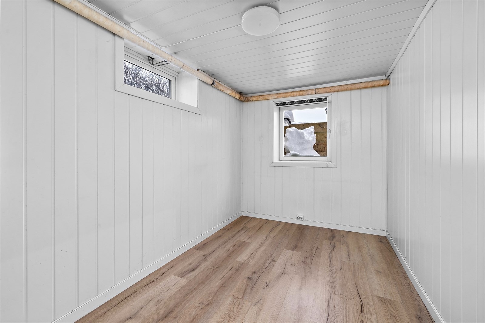 Rommene har panel på veggene og laminat på gulvet. Galleribilde