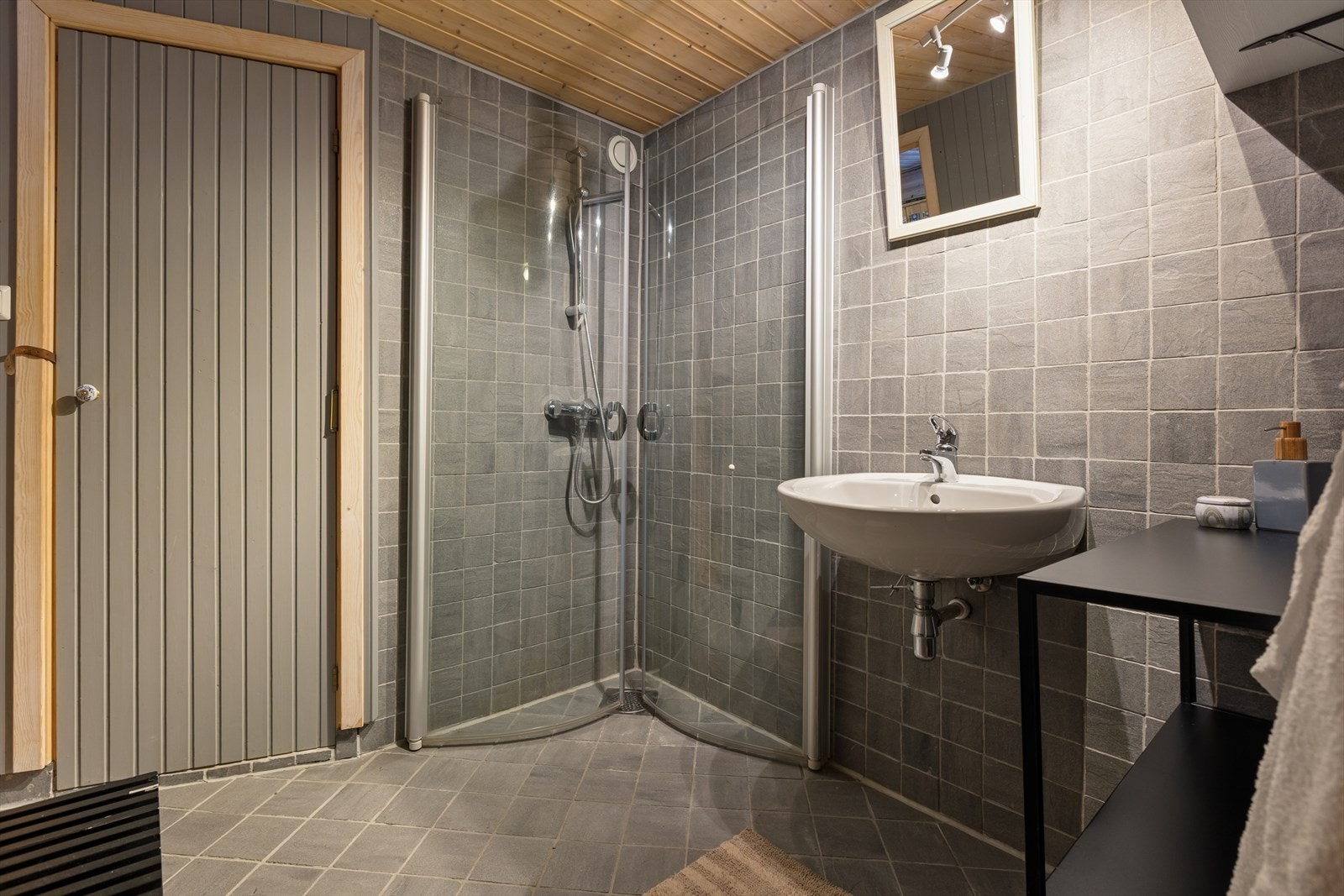 Badet er innredet med servant og dusjhjørne med dusjvegger. Galleribilde