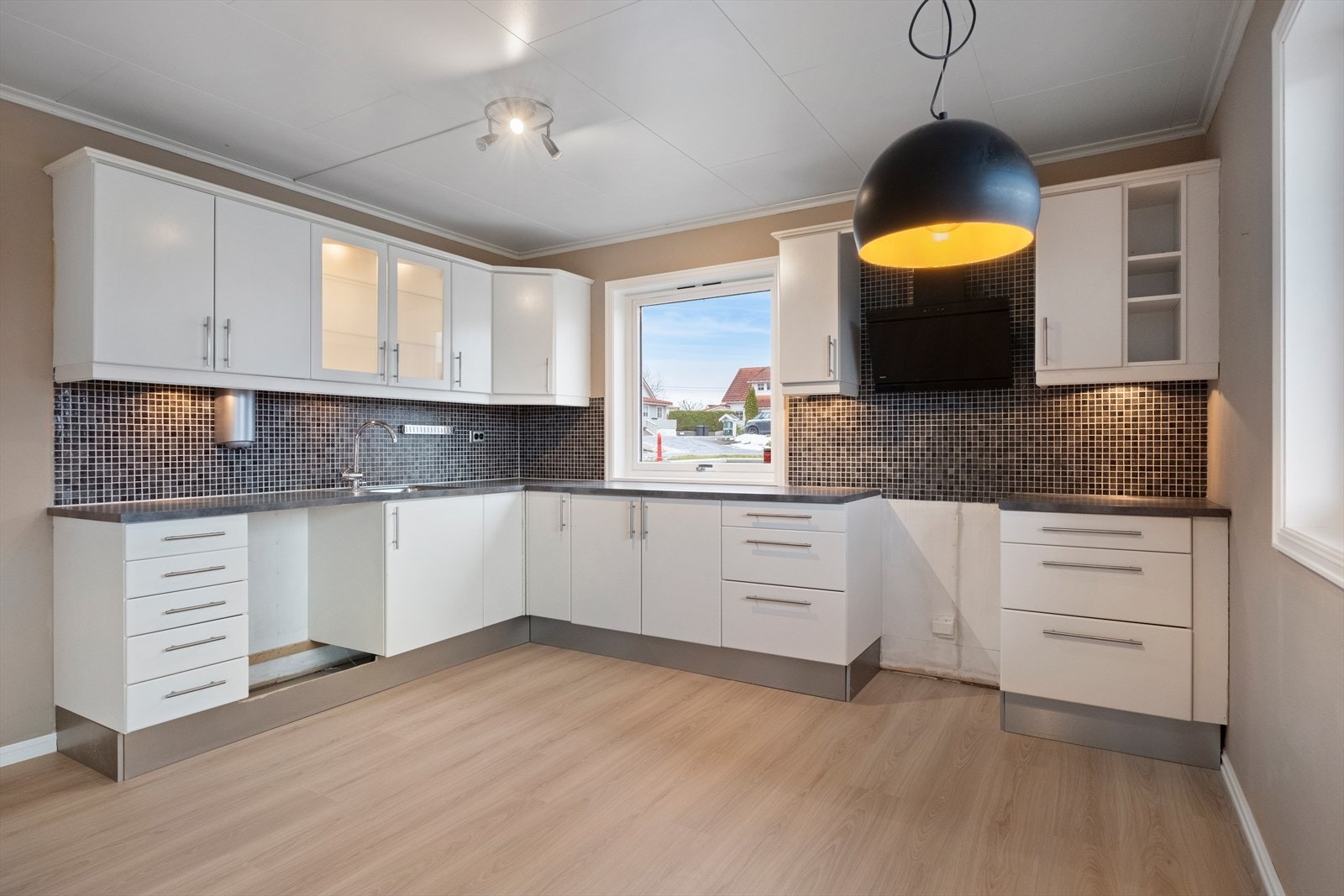 Kjøkkenet har innredning med glatte fronter og benkeplaten er av laminat. Galleribilde