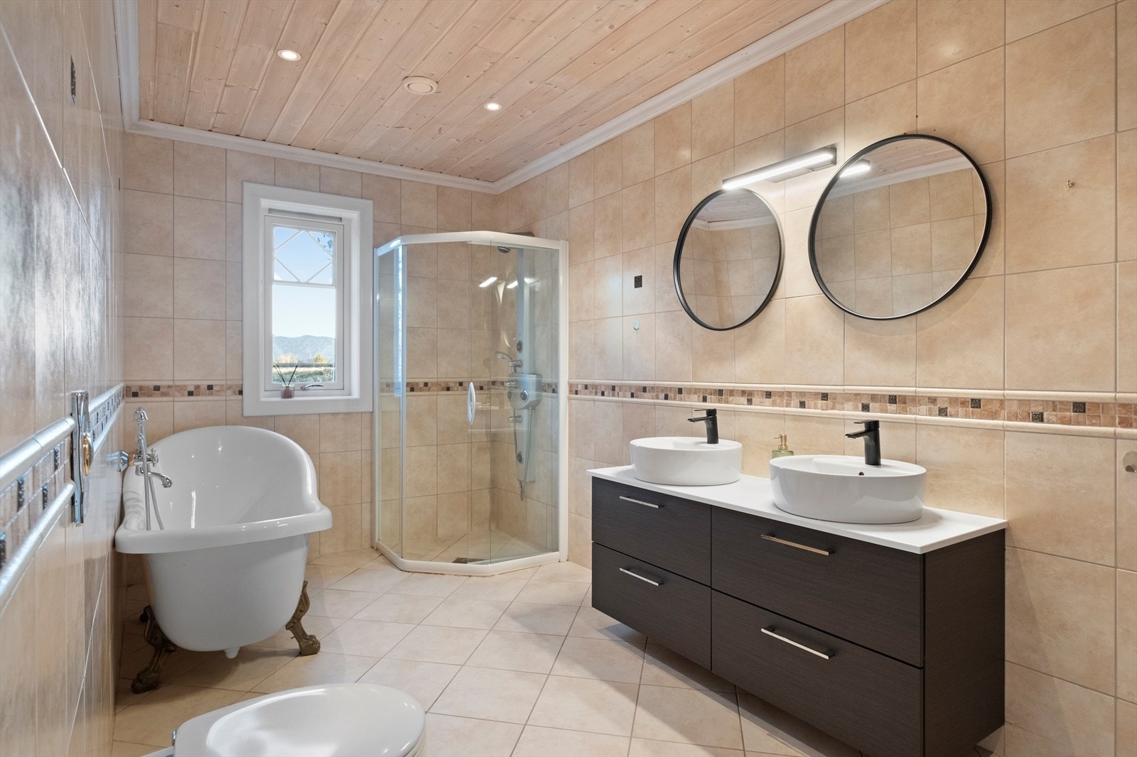 Pent bad med dobbel servant, badekar, dusj og vegghengt toalett. Galleribilde