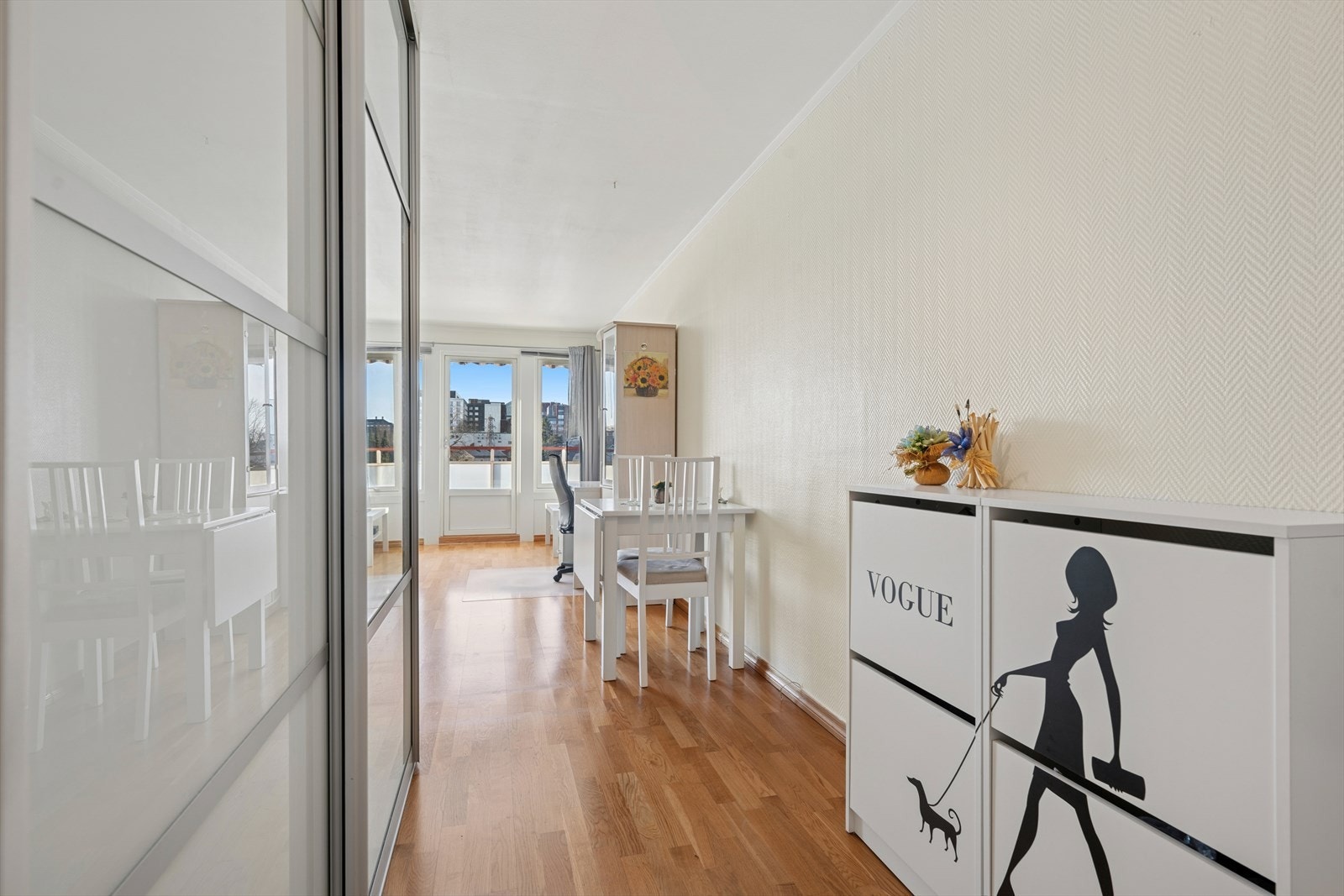 De store vinduene i stuen slipper inn rikelig med naturlig lys som strømmer helt gjennom rommet og videre ut i entréen. Galleribilde