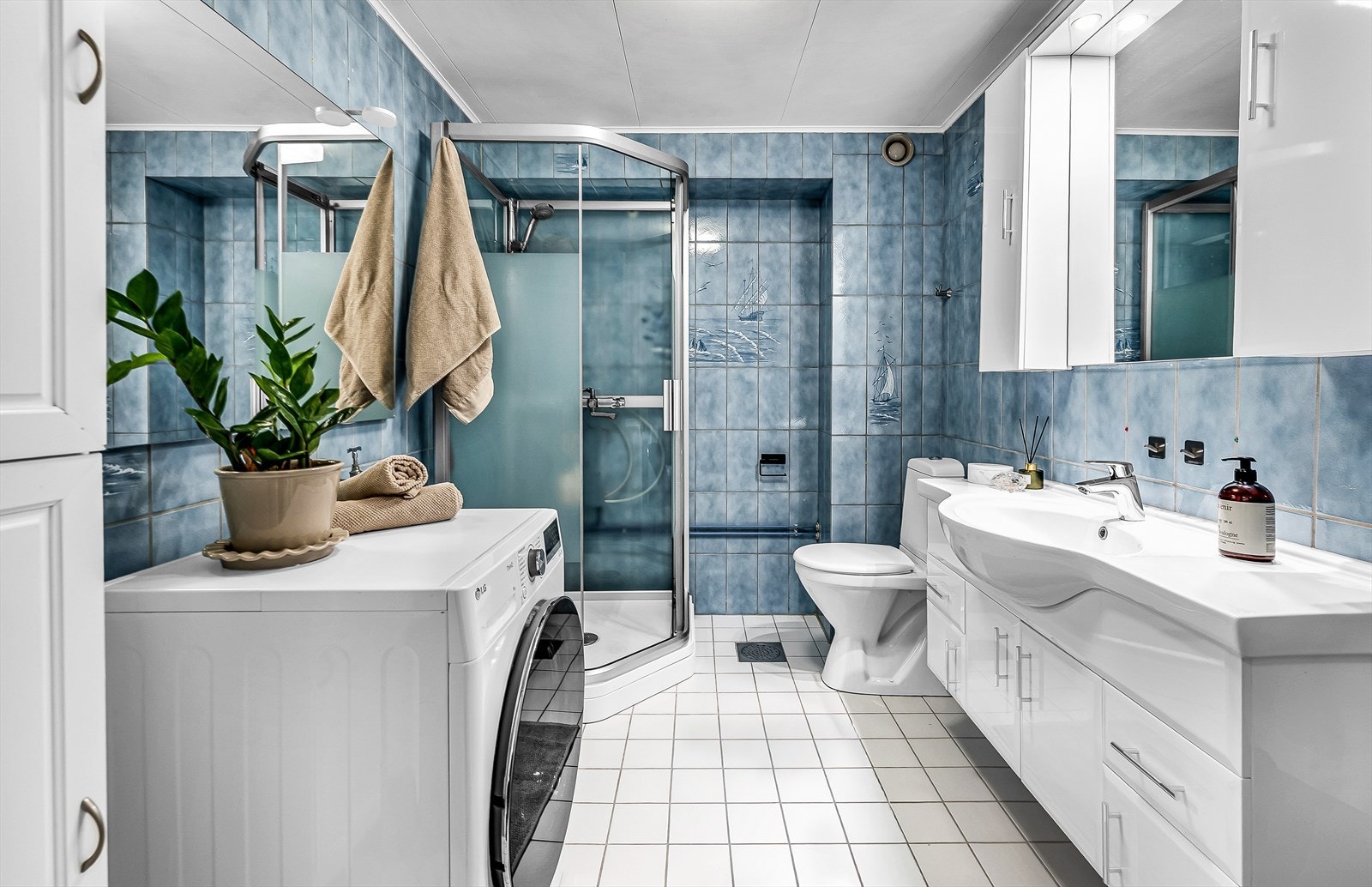 Baderom fra ukjent årstall(antatt før 2010) med fliser på vegger og malt himling. Dusjkabinett. Gulvmontert toalett. Servantinnredning og ett greps blandebatteri. Galleribilde