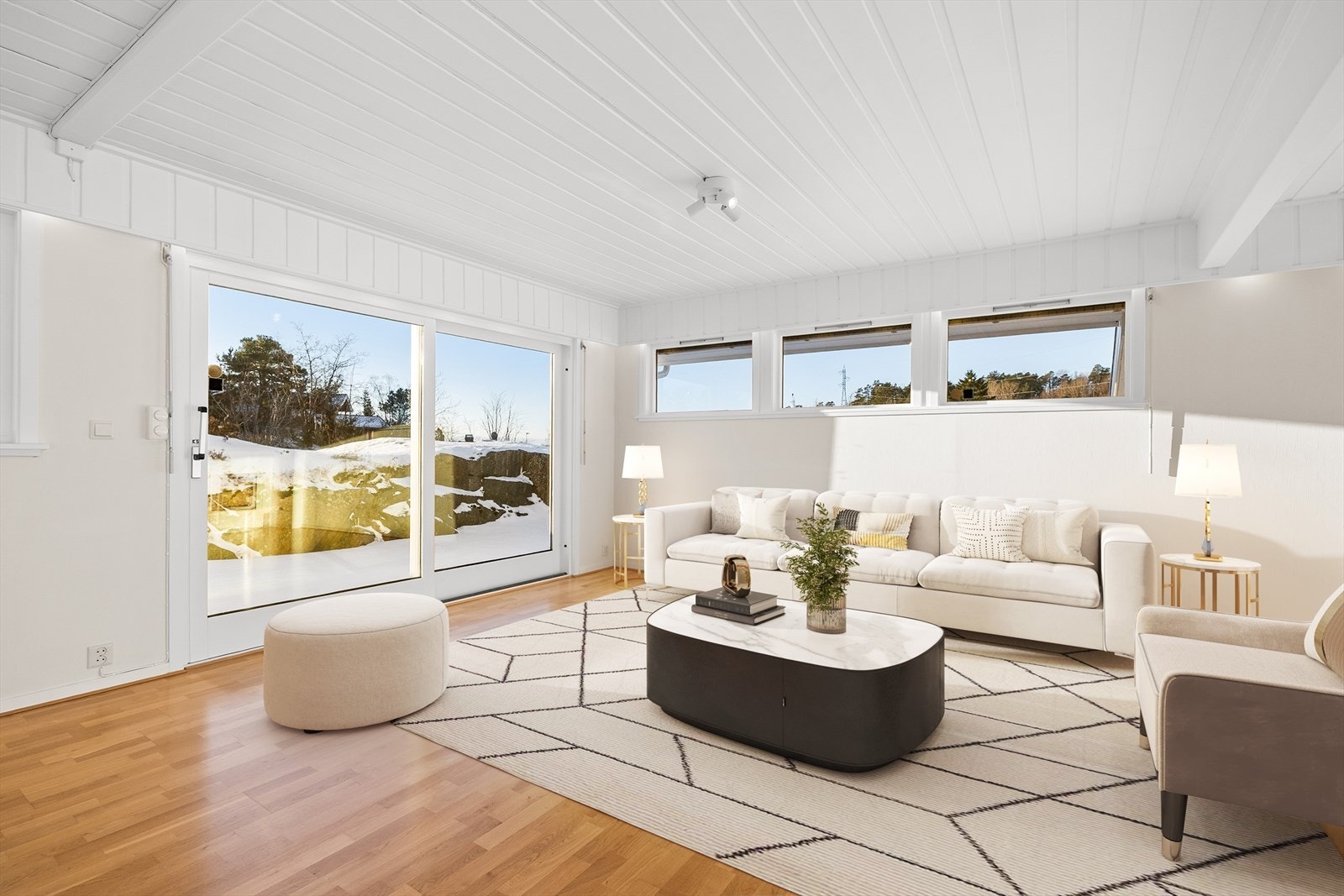 De store vindusflatene slipper inn rikelig med naturlig lys og skaper en luftig og behagelig atmosfære. De lyse, malte overflatene forsterker romfølelsen ytterligere og gir et moderne og tidsriktig uttrykk som er enkelt å tilpasse ulike møbelstiler. Galleribilde