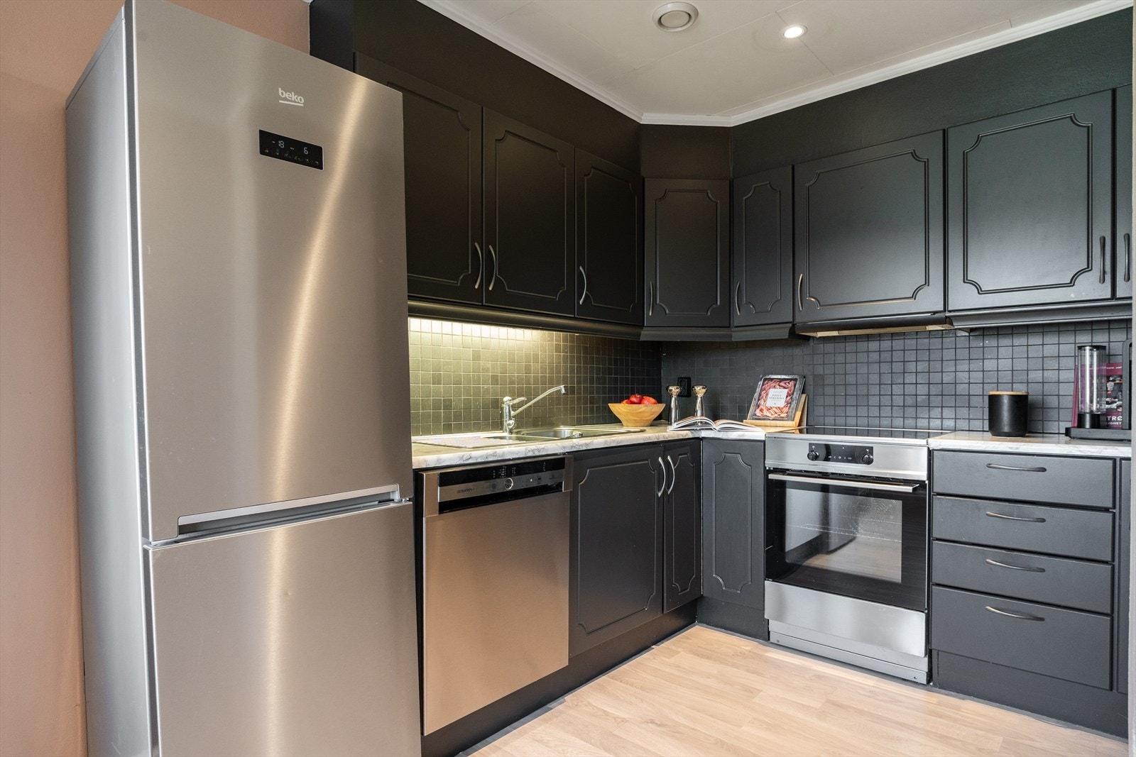 Mørk kjøkkeninnredning med god plass til det kjøkkenutstyret en trenger. Galleribilde