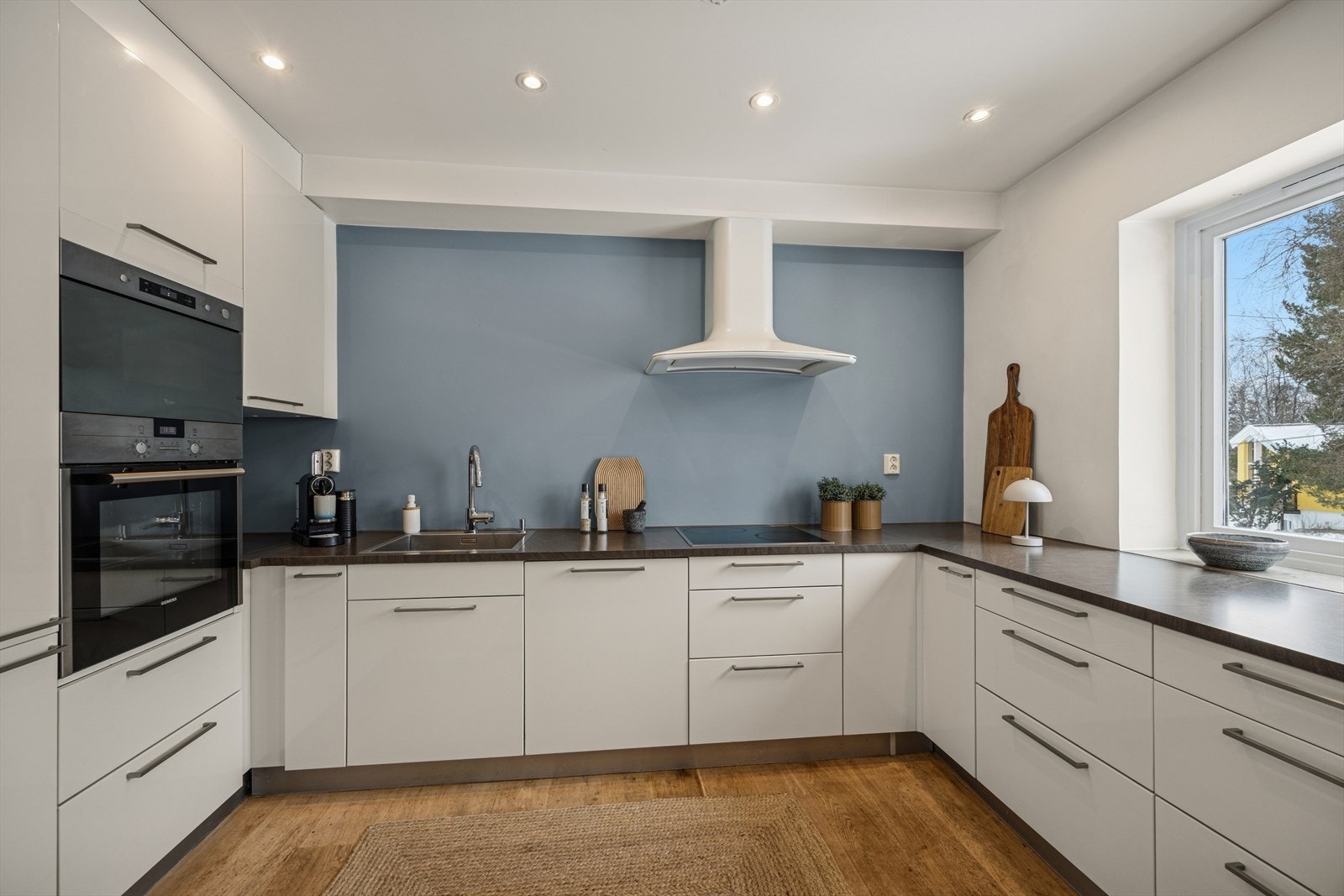 Kjøkken har integrerte hvitevarer og rikelig med benkeplass Galleribilde