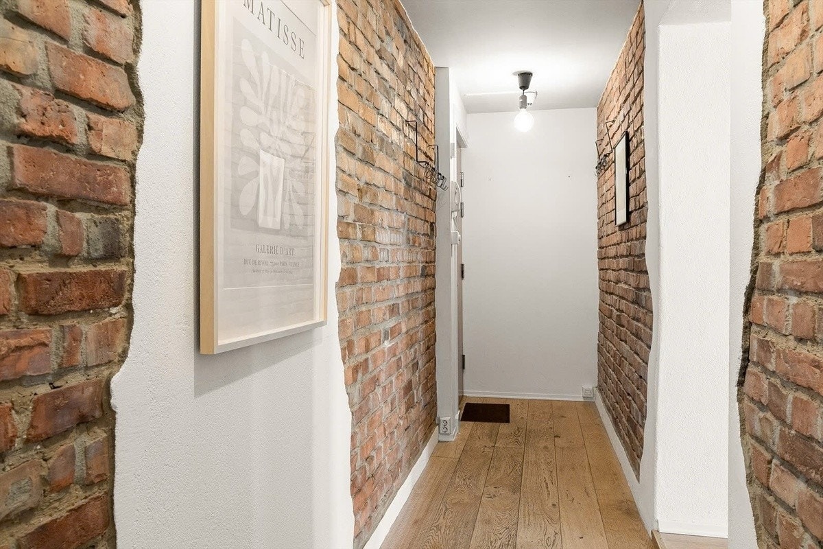 Gang med synlige murvegger og god oppbevaringsplass. Galleribilde