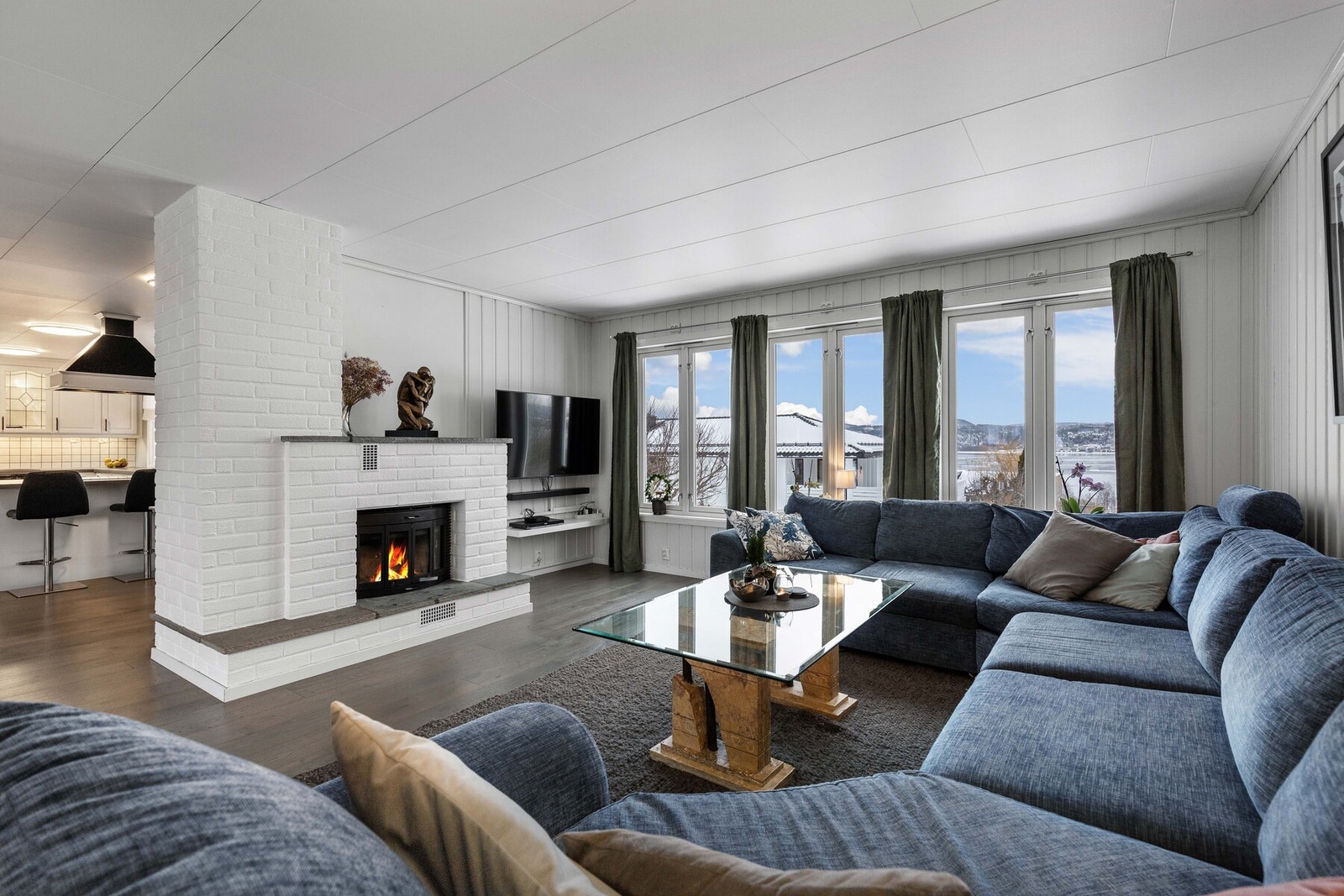 Lys og romslig stue med peis og store vindusflater. Galleribilde