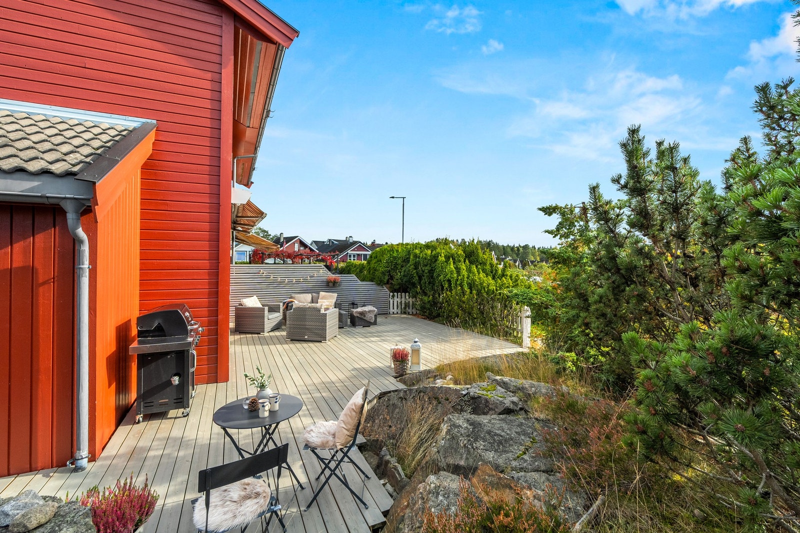Sjarmerende med terrasseplatting kombinert med tilliggende naturtomt. Omgivelsene oppleves luftig og skjermet. Plattingen ble lagt ny i 2024, og beiset tidligere i år. Galleribilde