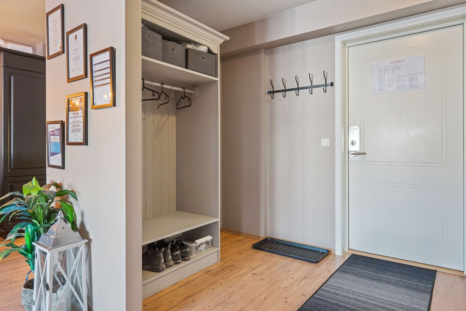Romslig entré med garderobeløsning med plass til å sette fra seg sko og henge fra seg yttertøyet. Galleribilde