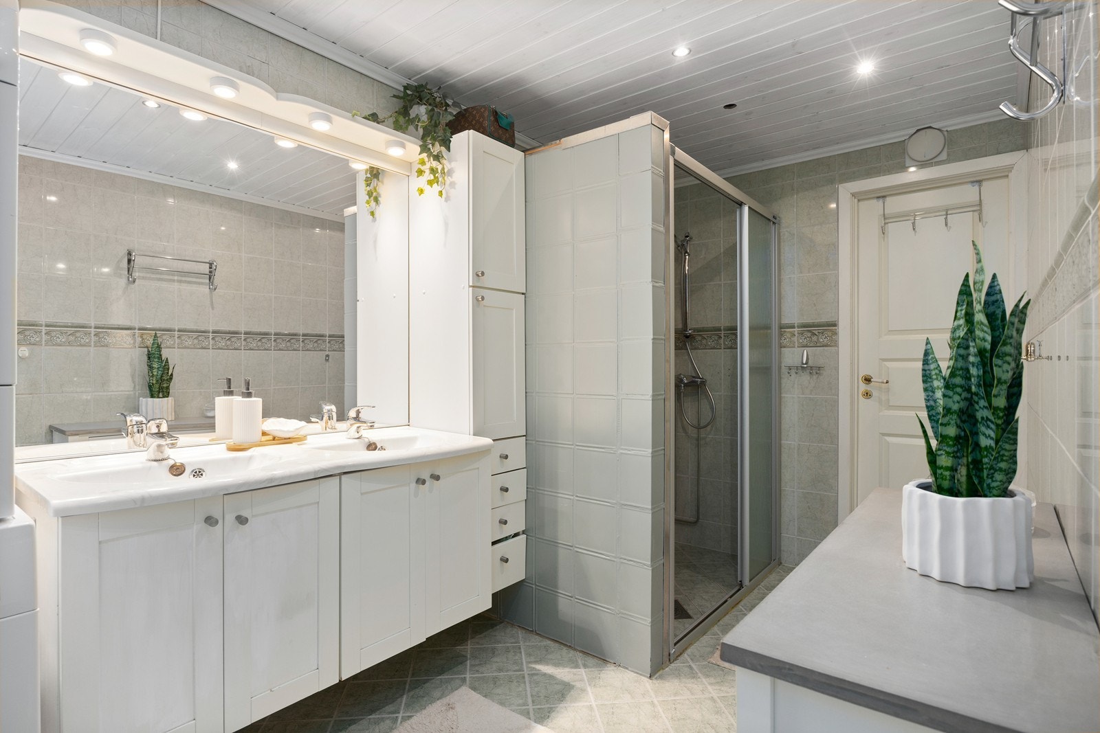 Baderommet ble pusset opp i 2006, i regi av en tidligere eier. Gulv og vegger er flislagt. Rommet er utstyrt med en større baderomsinnredning med to servanter, med speil over, samt høyskap for lagring. Dusjnisje med glassbyggerstein som er malt Galleribilde