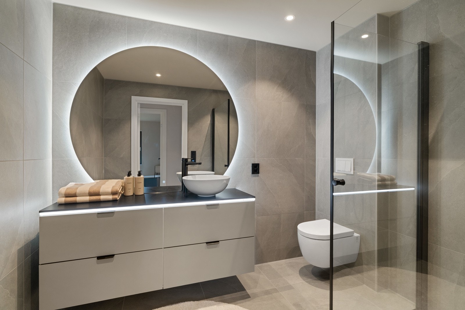 Hovedbadet er delikat og moderne med en innredning fra Viking Bad. Badet har 60x60 fliser, behagelig gulvvarme og downlights i himling. Det kan ved enkle grep etableres to servanter dersom det er ønskelig. Galleribilde