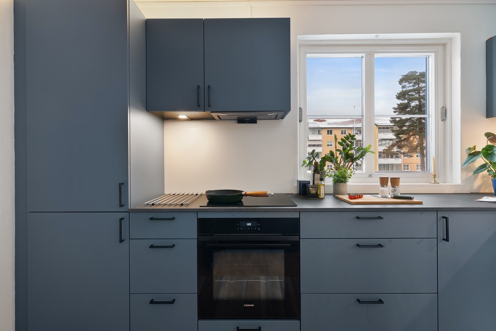 Kjøkkenet har innredning med glatte fronter og benkeplaten er av laminat. Galleribilde