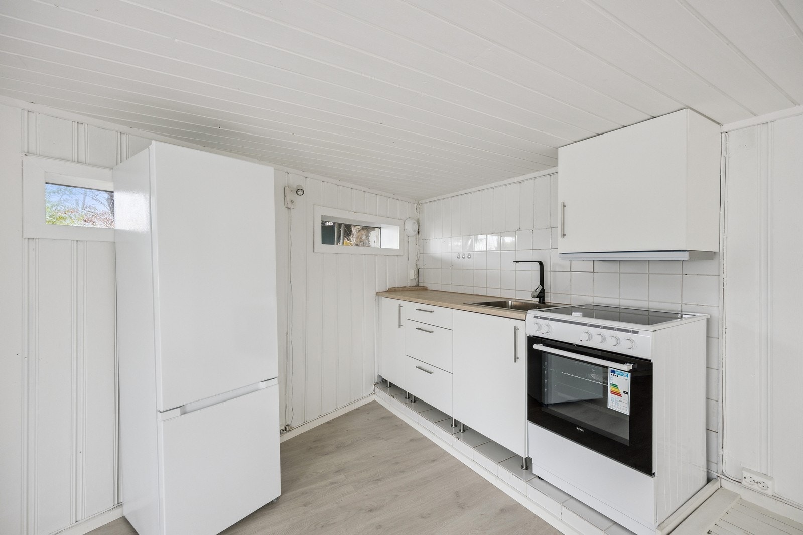 Kjøkken med kombiskap og komfyr. Galleribilde