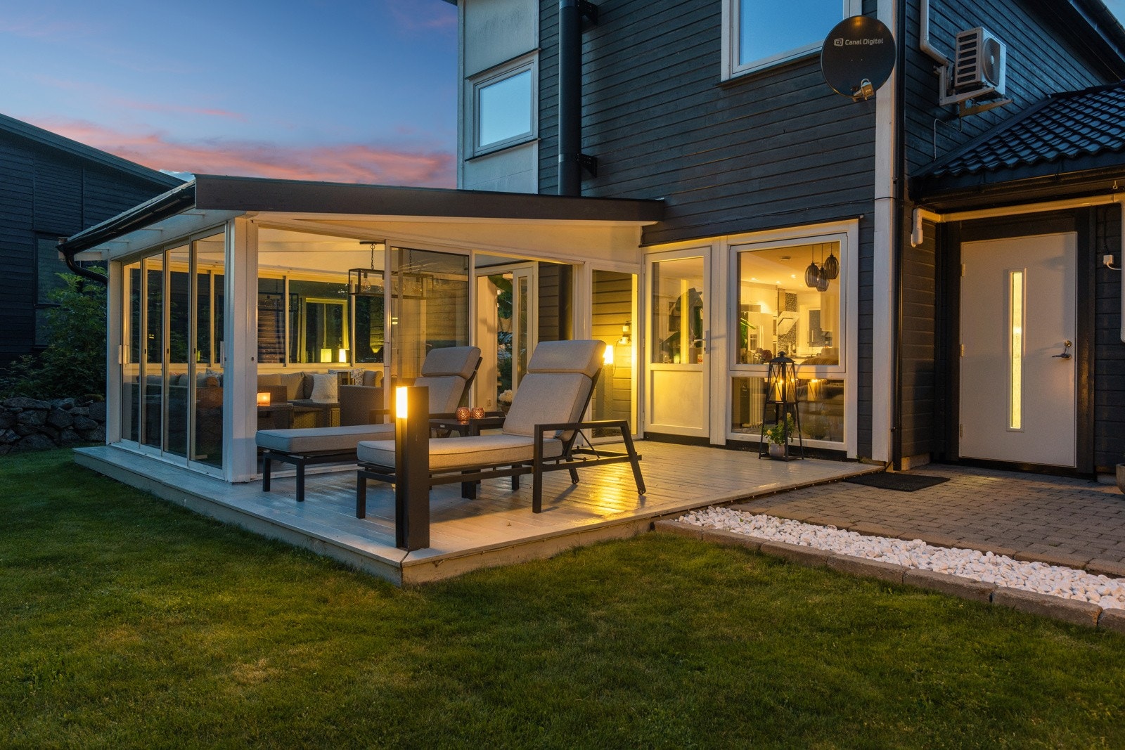 Fasaden er pent opparbeidet med belegningsstein foran og bak. Det er to terrasser som er beiset og malt. Galleribilde