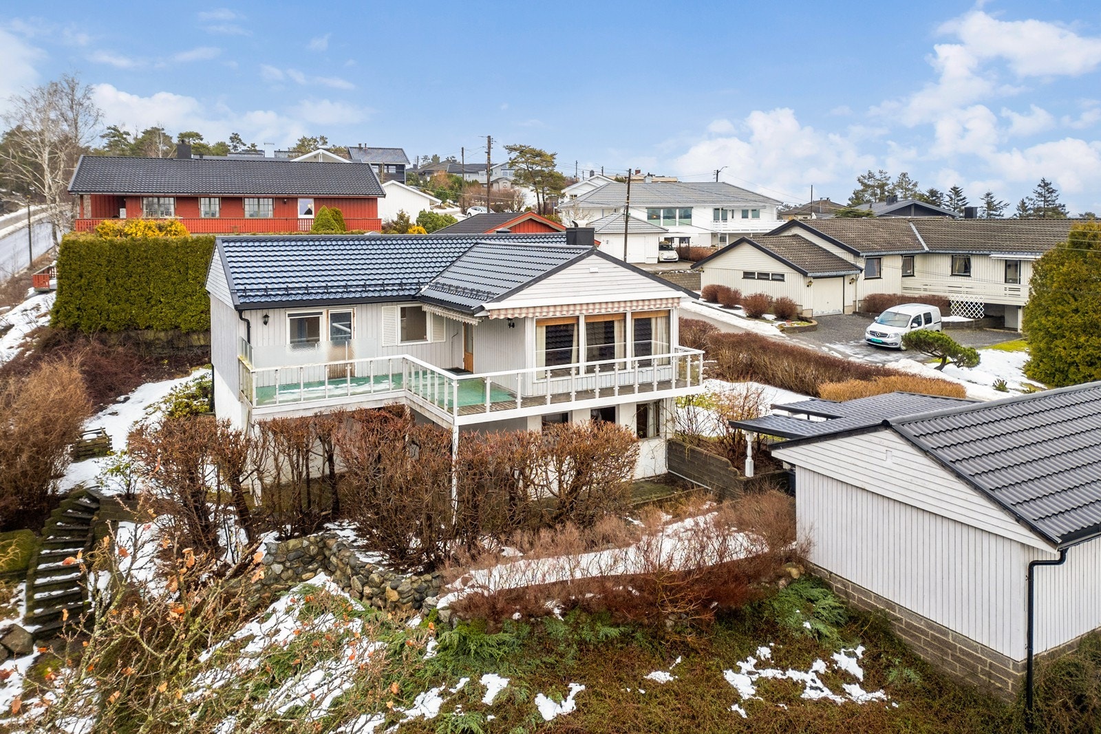 Eneboligen med hybel ble oppført i 1973 med skrånende tomt mot syd og en stor veranda. På tomten er det oppført en frittstående garasje med innlagt strøm og carport. Innkjørsel og gårdsplass er belagt med belegningsstein. Galleribilde