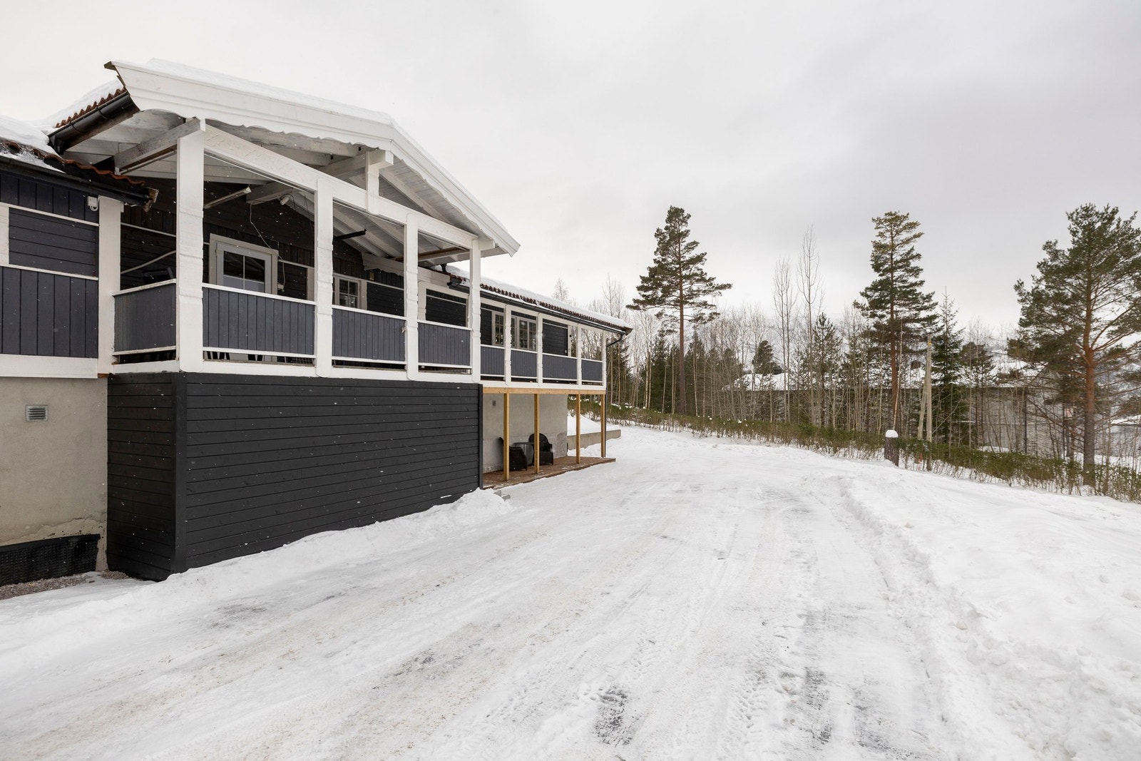 Boligens fasade med overbygd veranda. Galleribilde