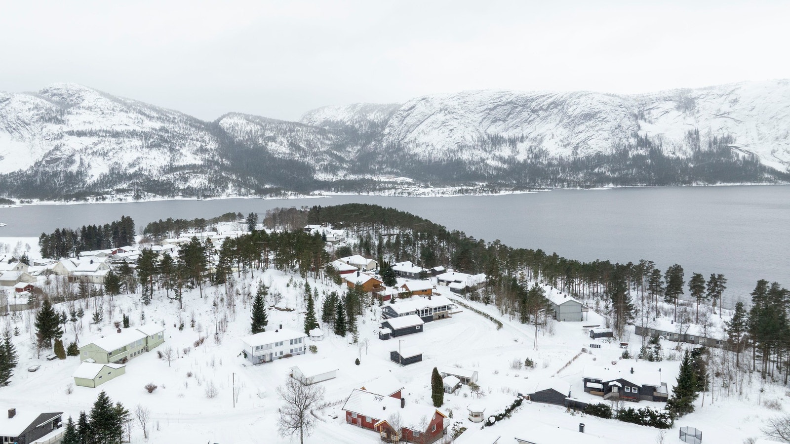 Vidstrakt utsikt mot vann og fjell, som gir området en lun og naturnær atmosfære året rundt. Galleribilde
