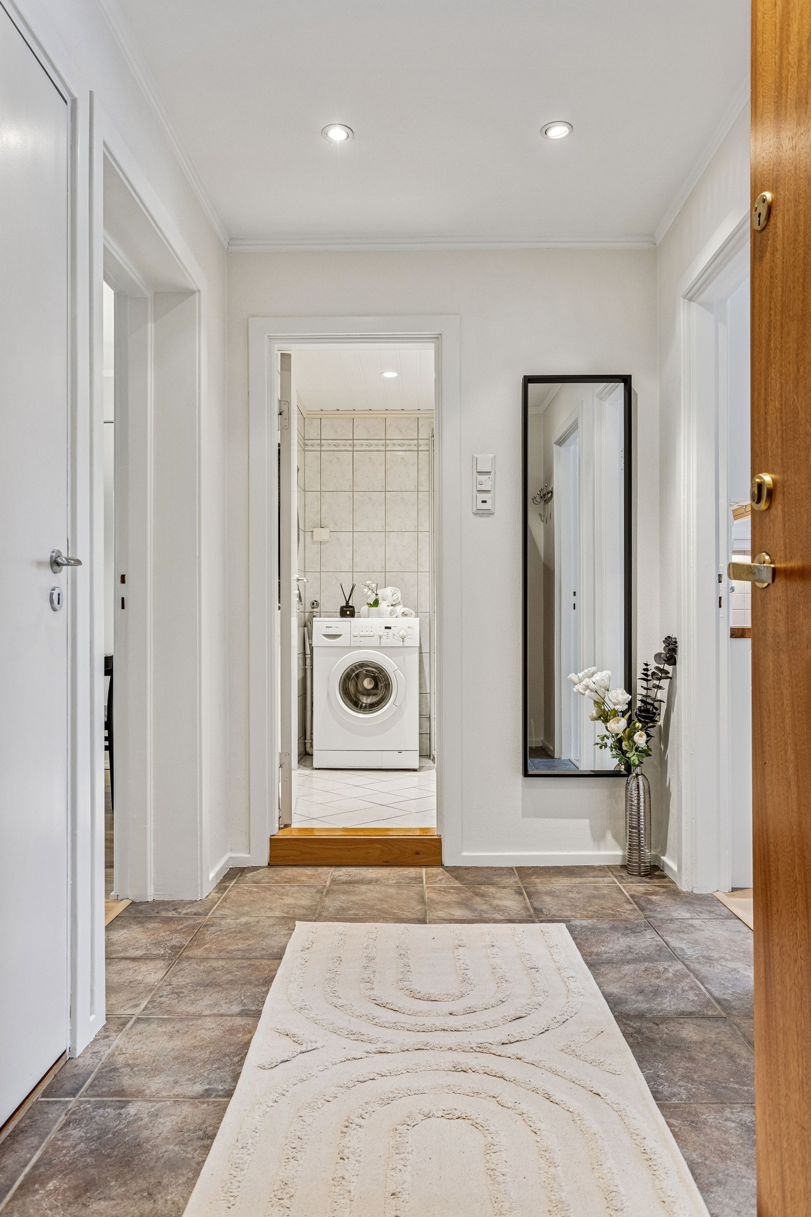 Romslig entré med praktisk garderobekott med kurvhyller og lagringsplass. Galleribilde