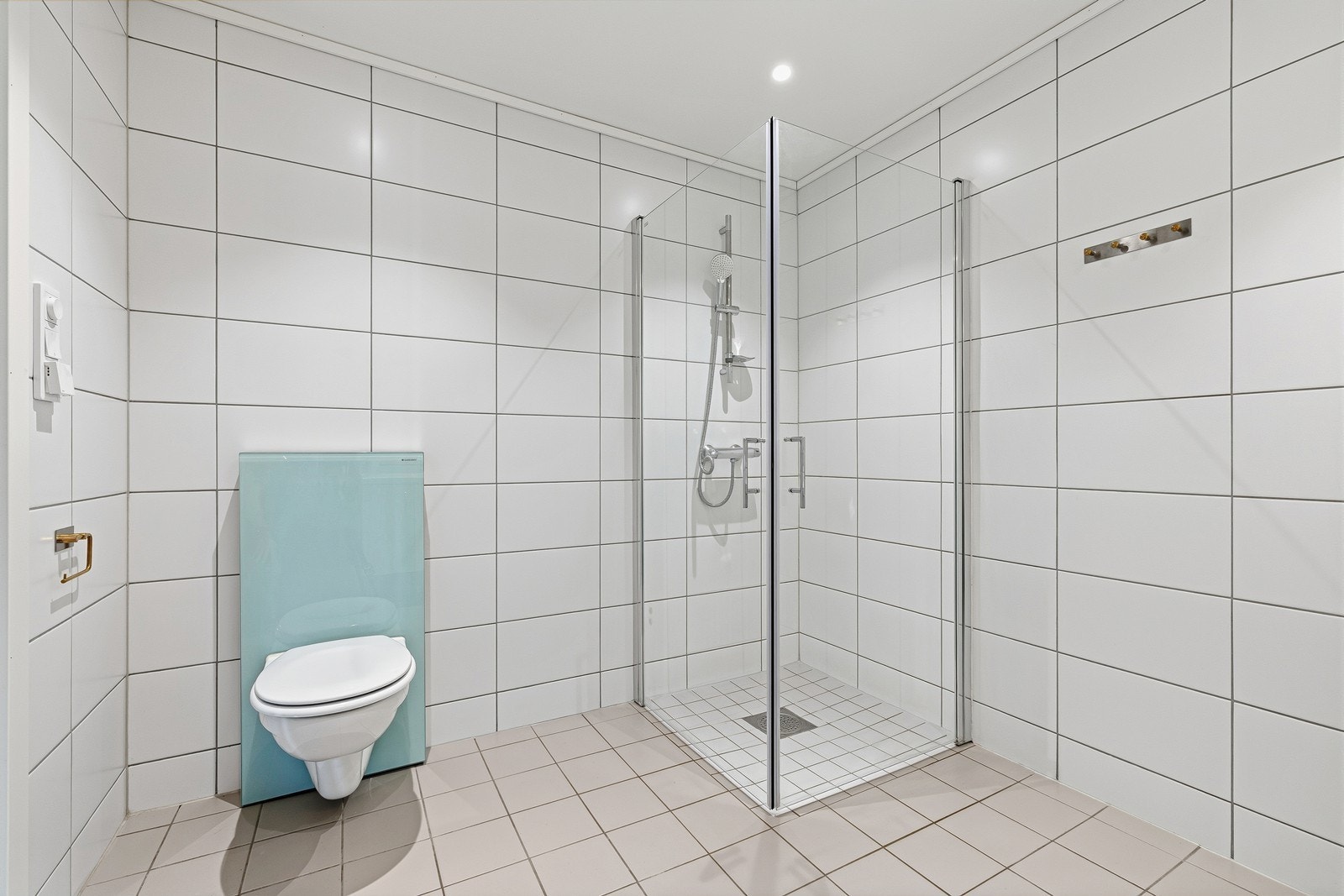 Lyst og pent, flislagt bad med vannbåren gulvvarme og downlights i tak. Galleribilde