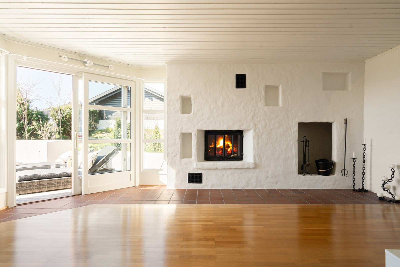 Skyve-/hevedør leder direkte til den store terrassen. På varme sommerdager er det behagelig svalt i kjellerstuen. Galleribilde