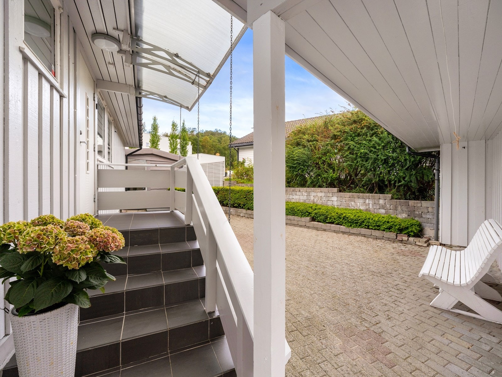 Fliselagt trapp og overbygget inngangsparti. Galleribilde