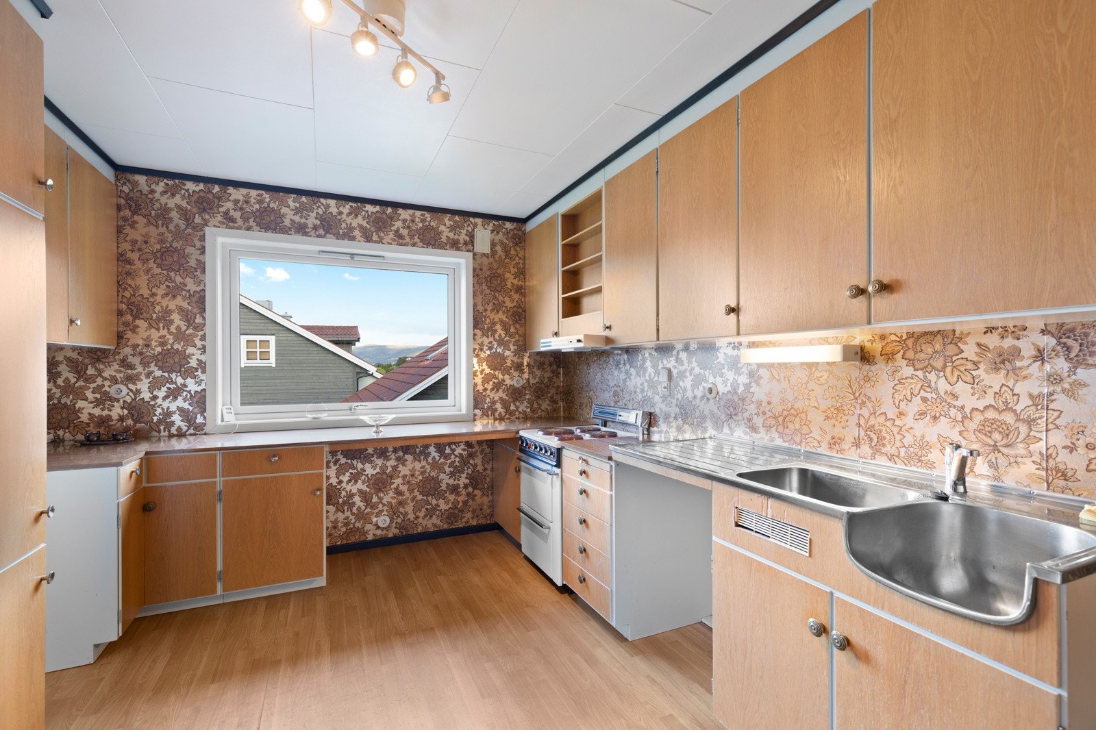 Innredningen er utsyrt med laminat benkeplate, benkebeslag med oppvaskkum, ventilator og opplegg for komfyr. Galleribilde