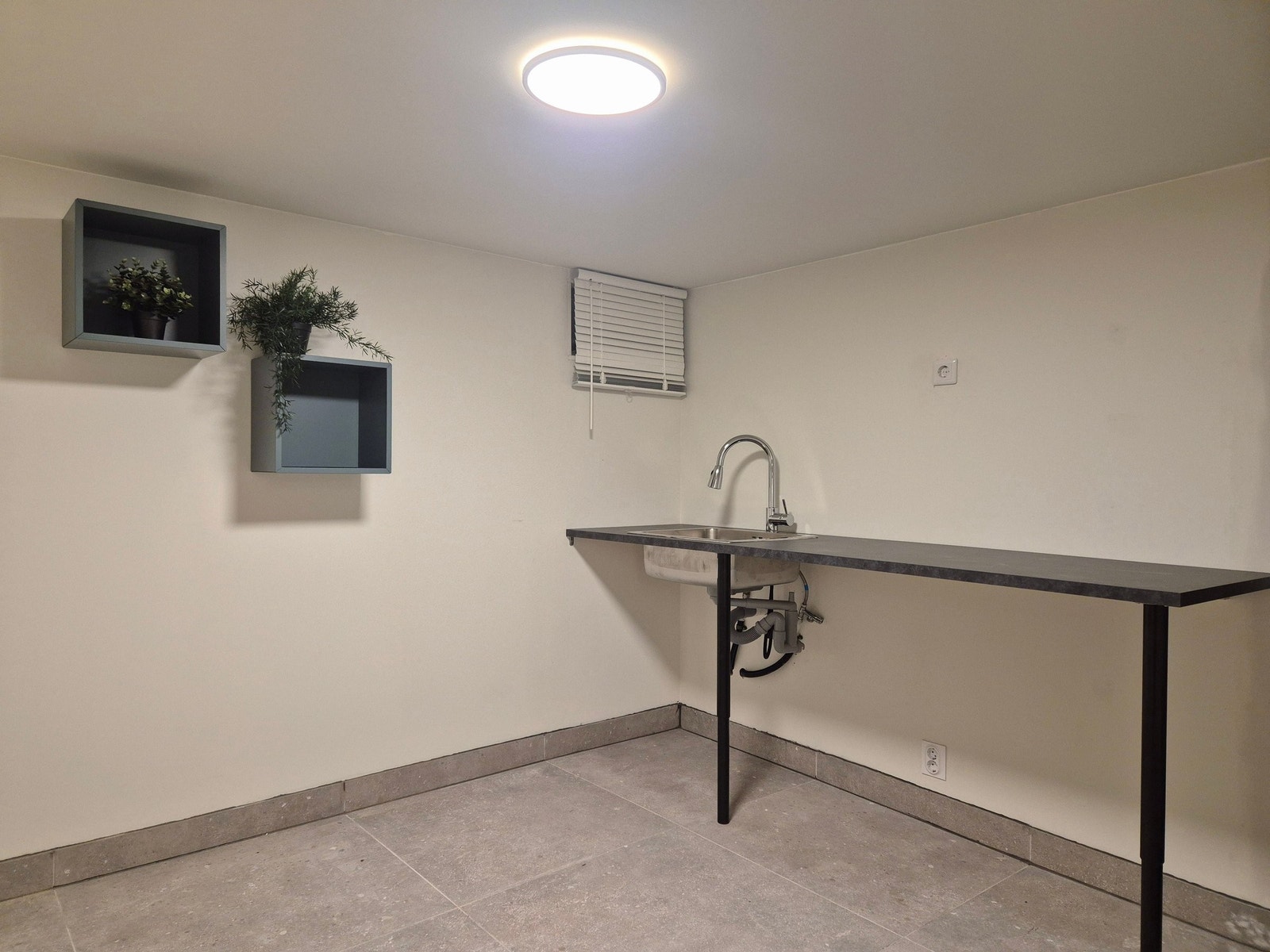 Eget vaskerom i kjeller med benkeplate og plass til vaskemaskin og tørketrommel. Utrekkbar kran. Galleribilde